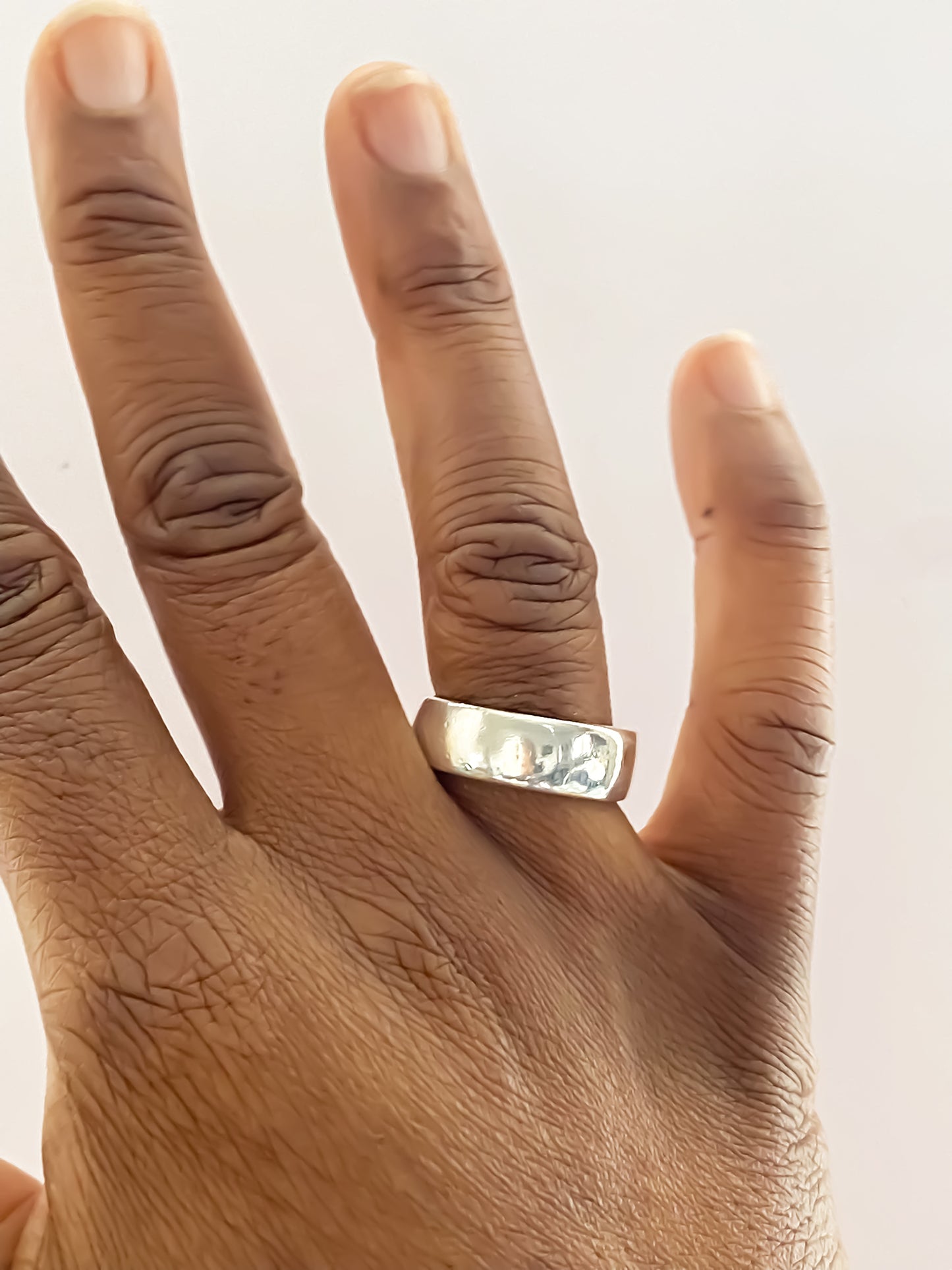 Studio view of Wide Band Ring lying flat - unisex, subtle wedding band bold gold or silver free shipping