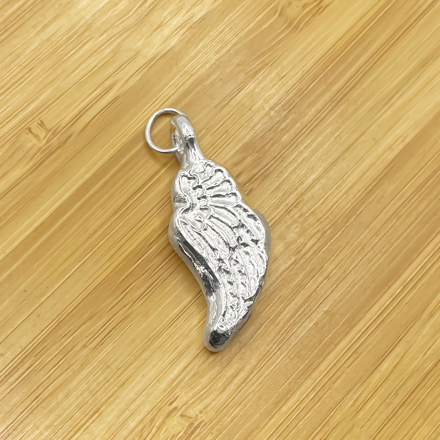 Close-up of Angel Wing Pendant with detailed feather texture, guardian 11:11 gold or silver free shipping