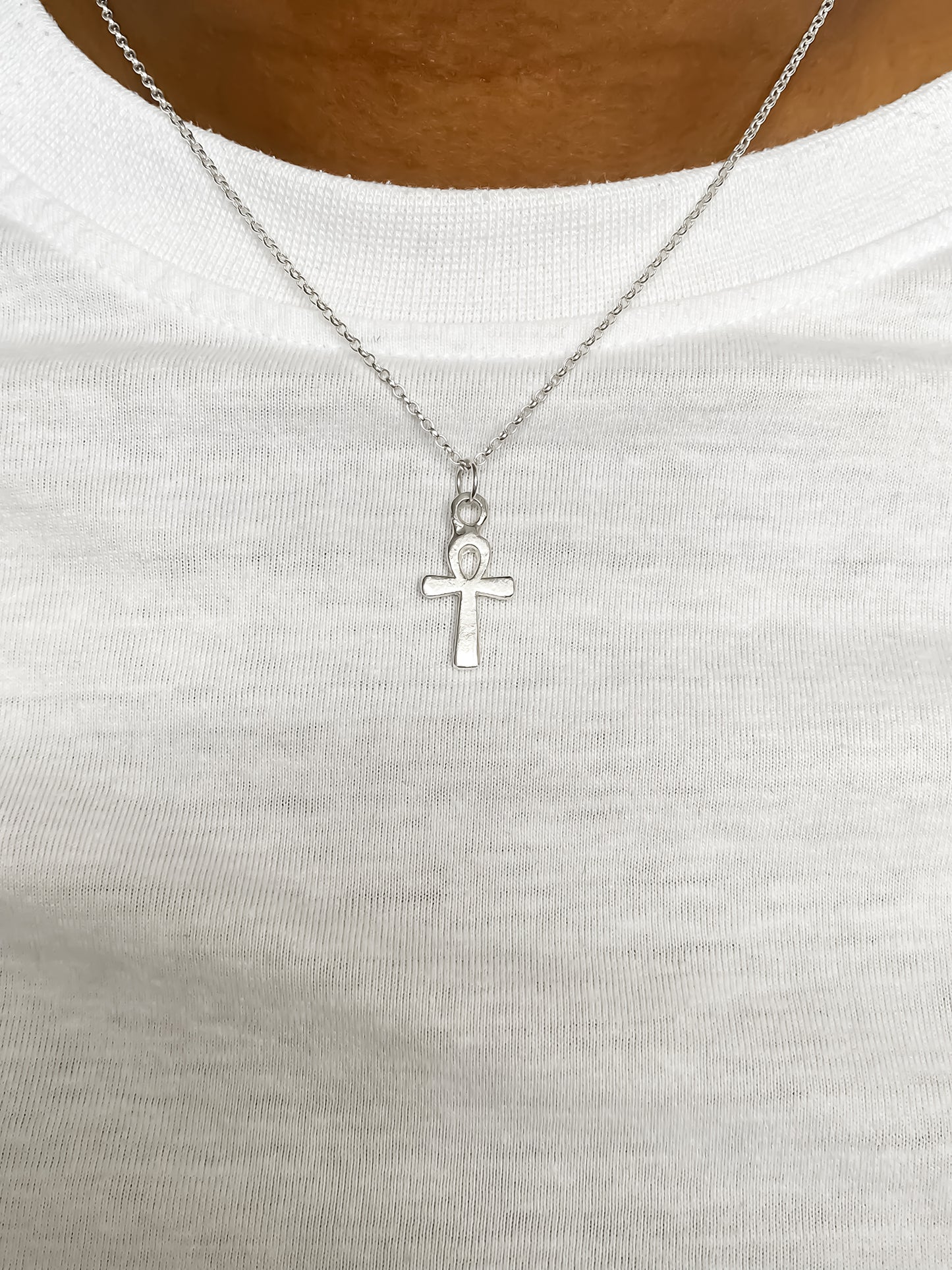 Ankh Pendant on white cloth background in silver or gold. Egyptian African