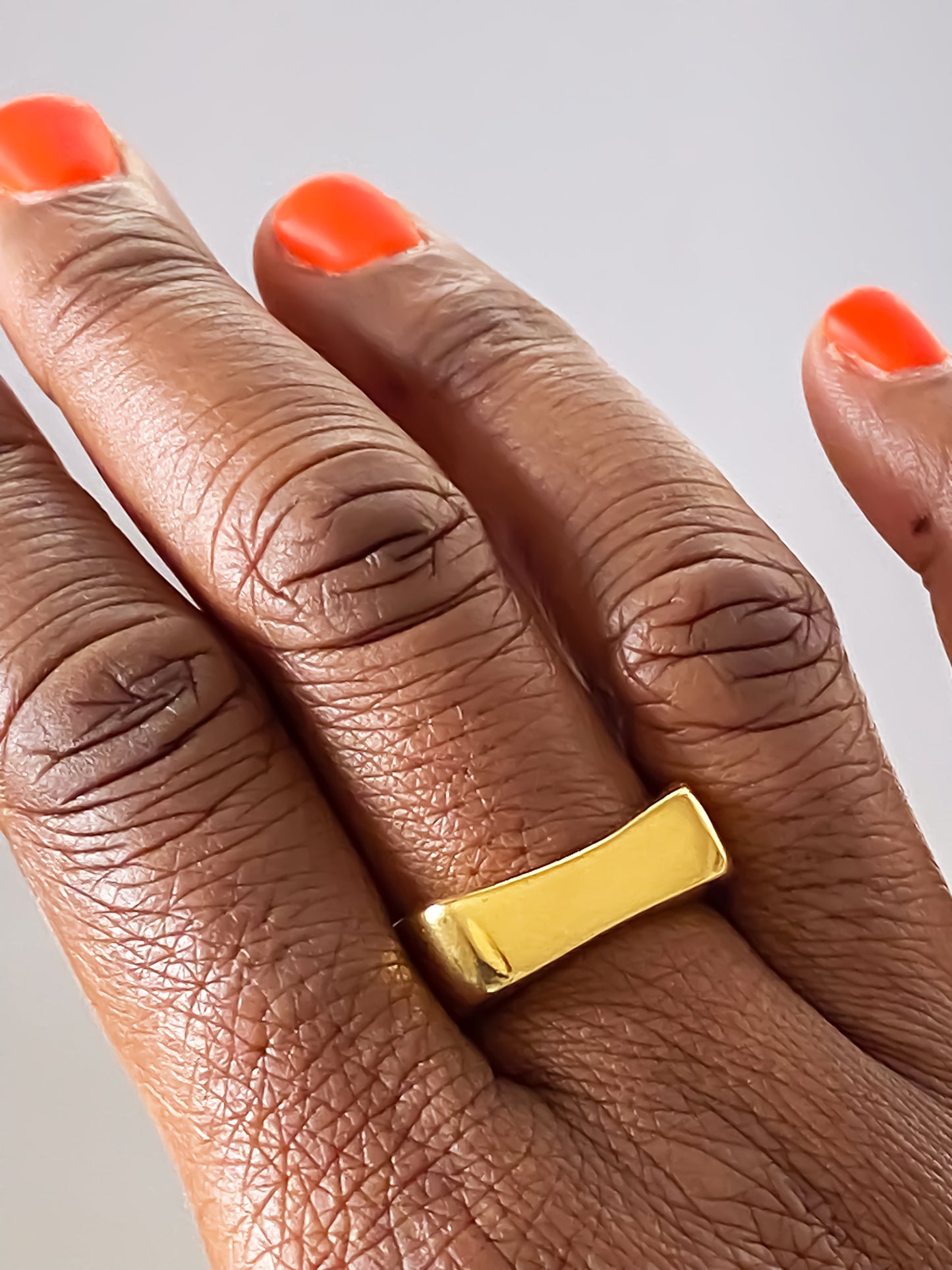 Close-up of MOCA Jewellery’s asymmetric bow ring in radiant gold