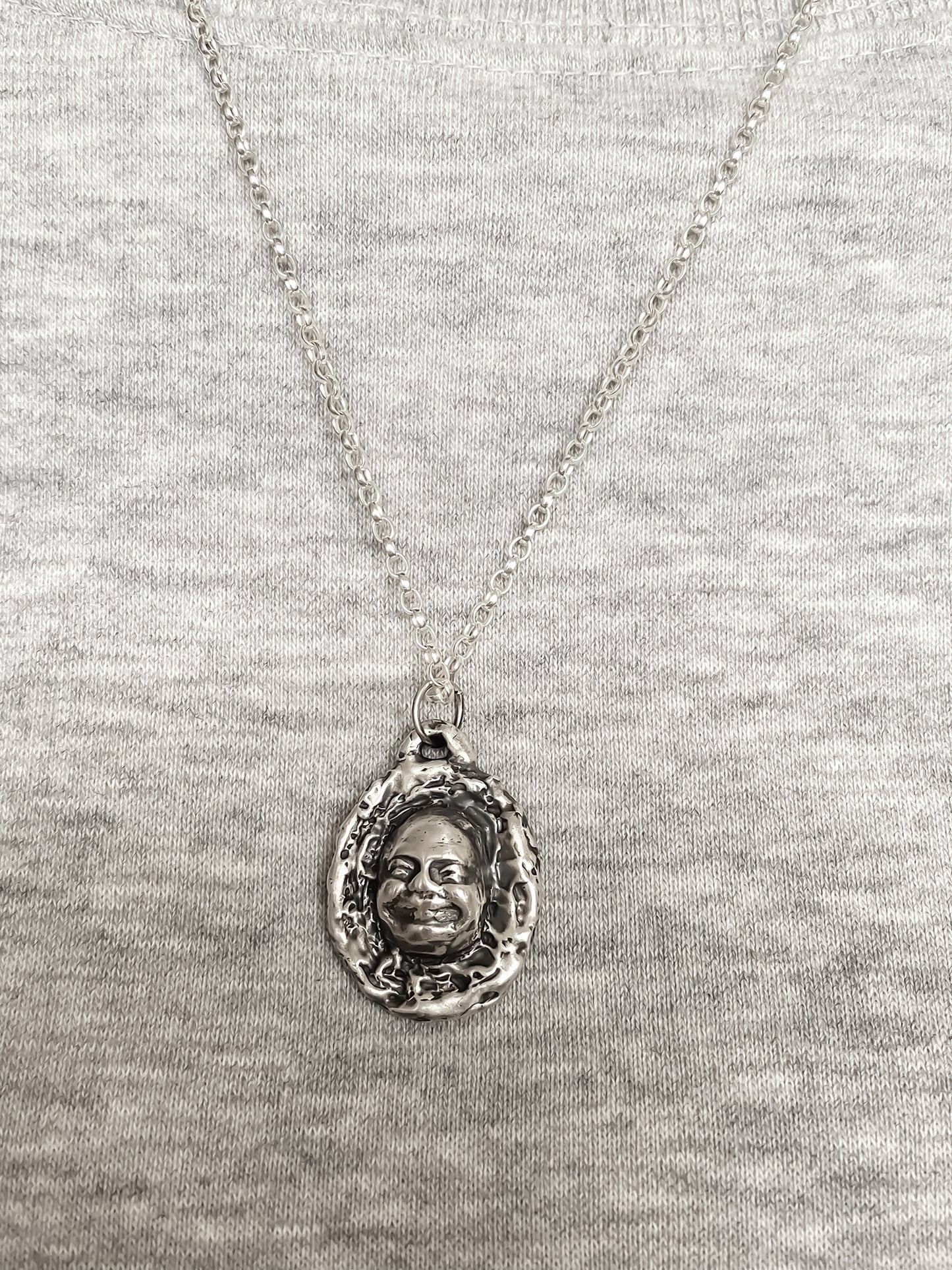 Happy Buddha Face Pendant styled with grey knit backdrop - happy buddha, spiritual, oxidised organic texture gold or silver free shipping