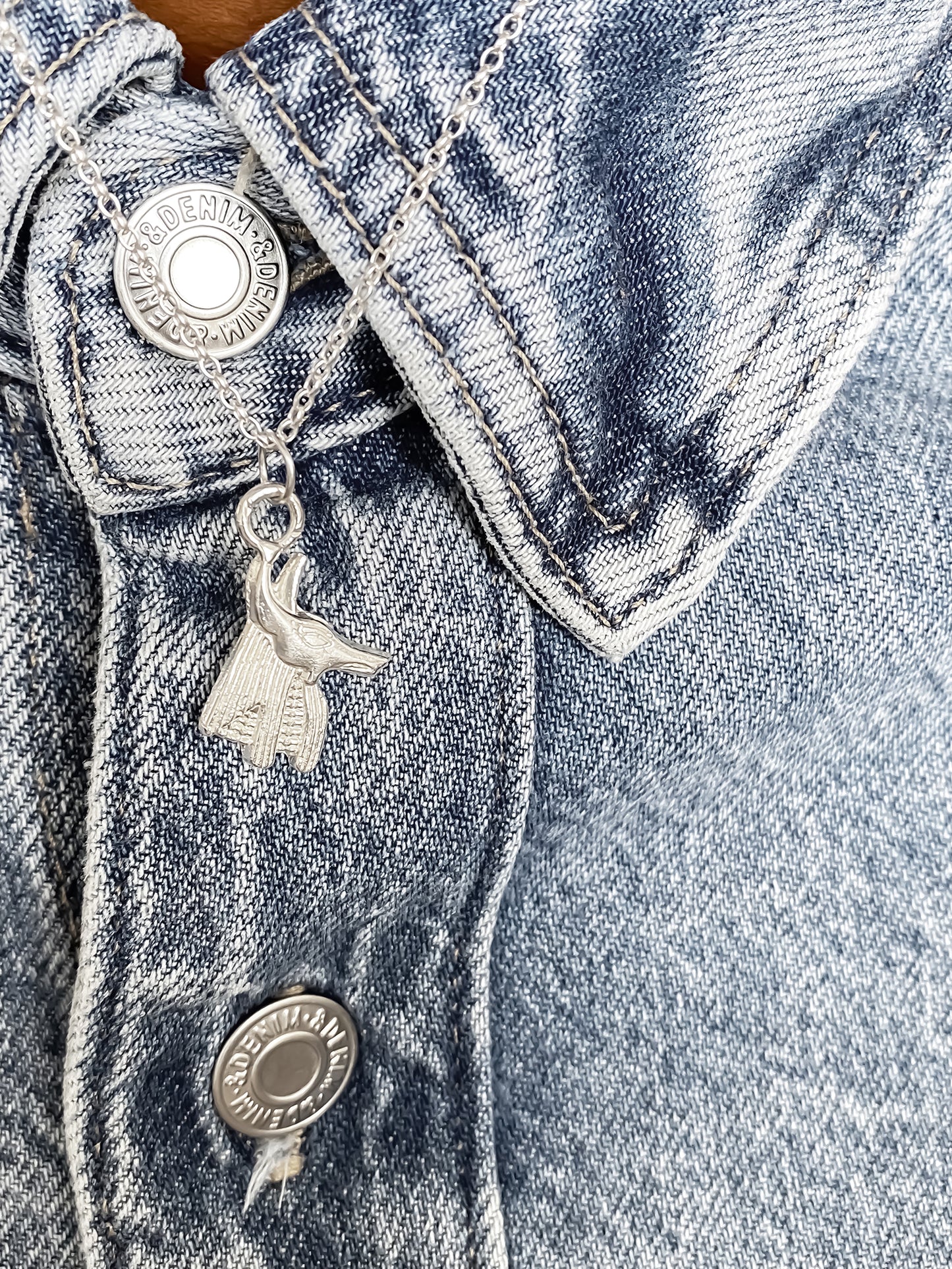 Close-up of Anubis Pendant on denim, African Ancient Egyptian Afterlife Guardian motif in silver or gold, free shipping