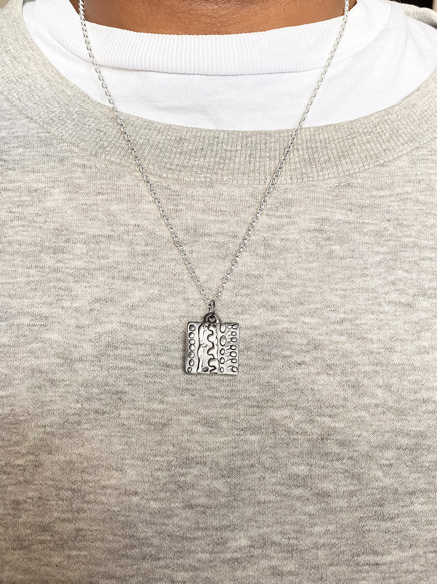 Dotty Pendant worn by model in soft light - textured, square happy buddha, oxidised organic texture gold or silver free shipping