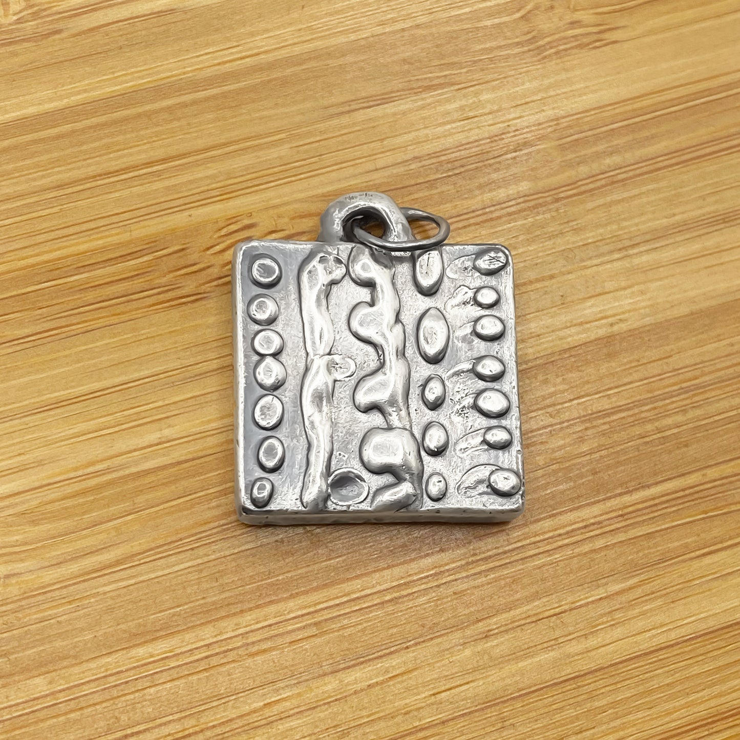Dotty Pendant laid on wood showing bold texture - textured, square happy buddha, oxidised organic texture gold or silver free shipping