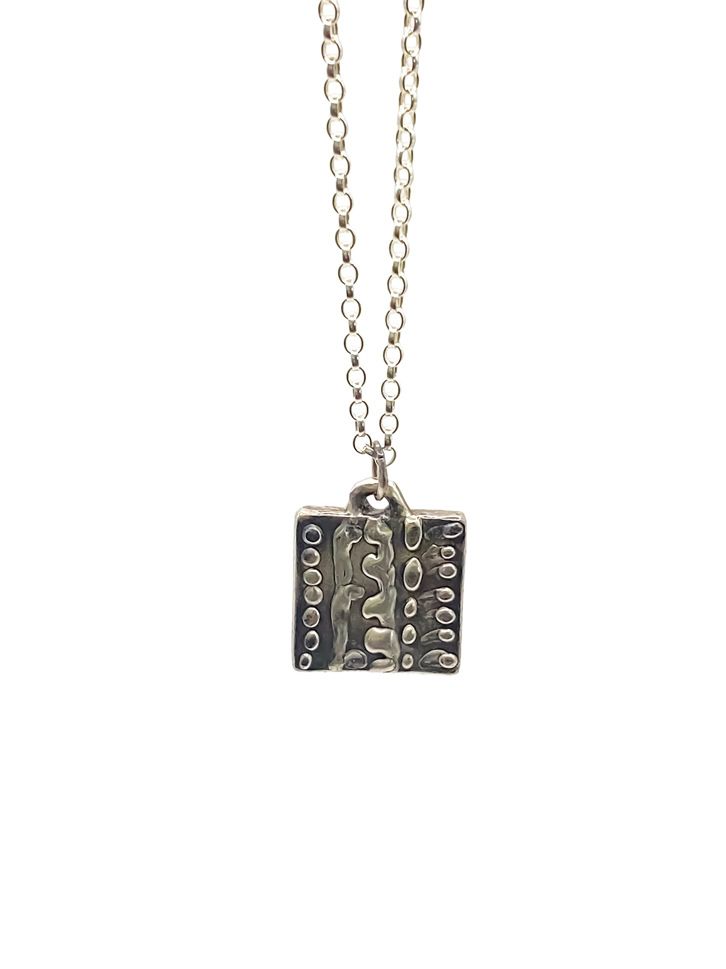 Close-up studio shot of Dotty Pendant in silver - textured, square happy buddha, oxidised organic texture gold or silver free shipping