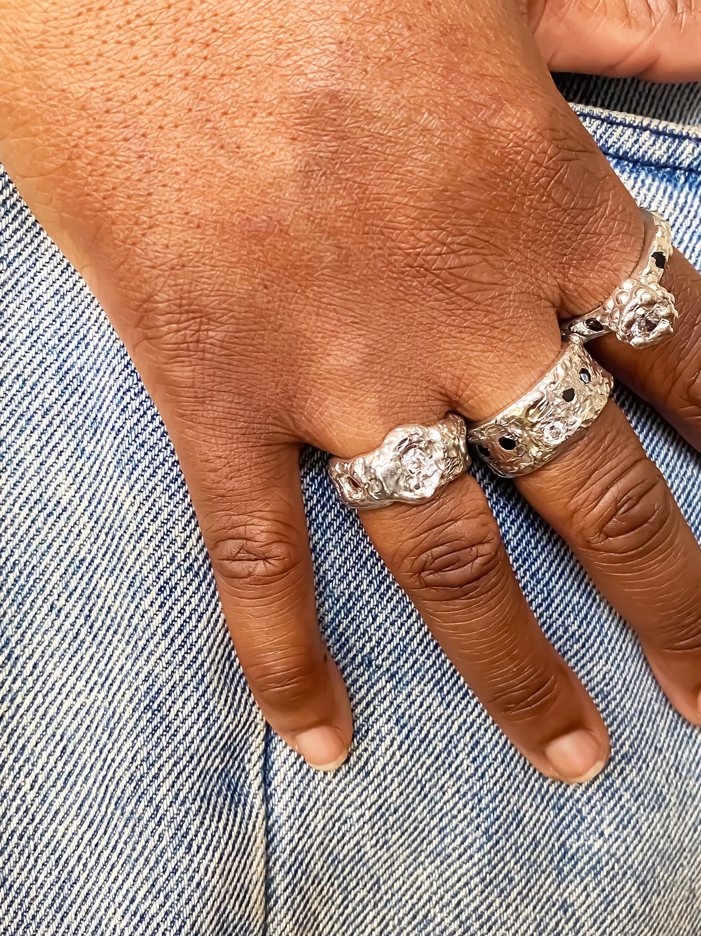 Hand shot showing variation of Eclipse Cutout Rings - textured band white and black gemstones gold or silver free shipping