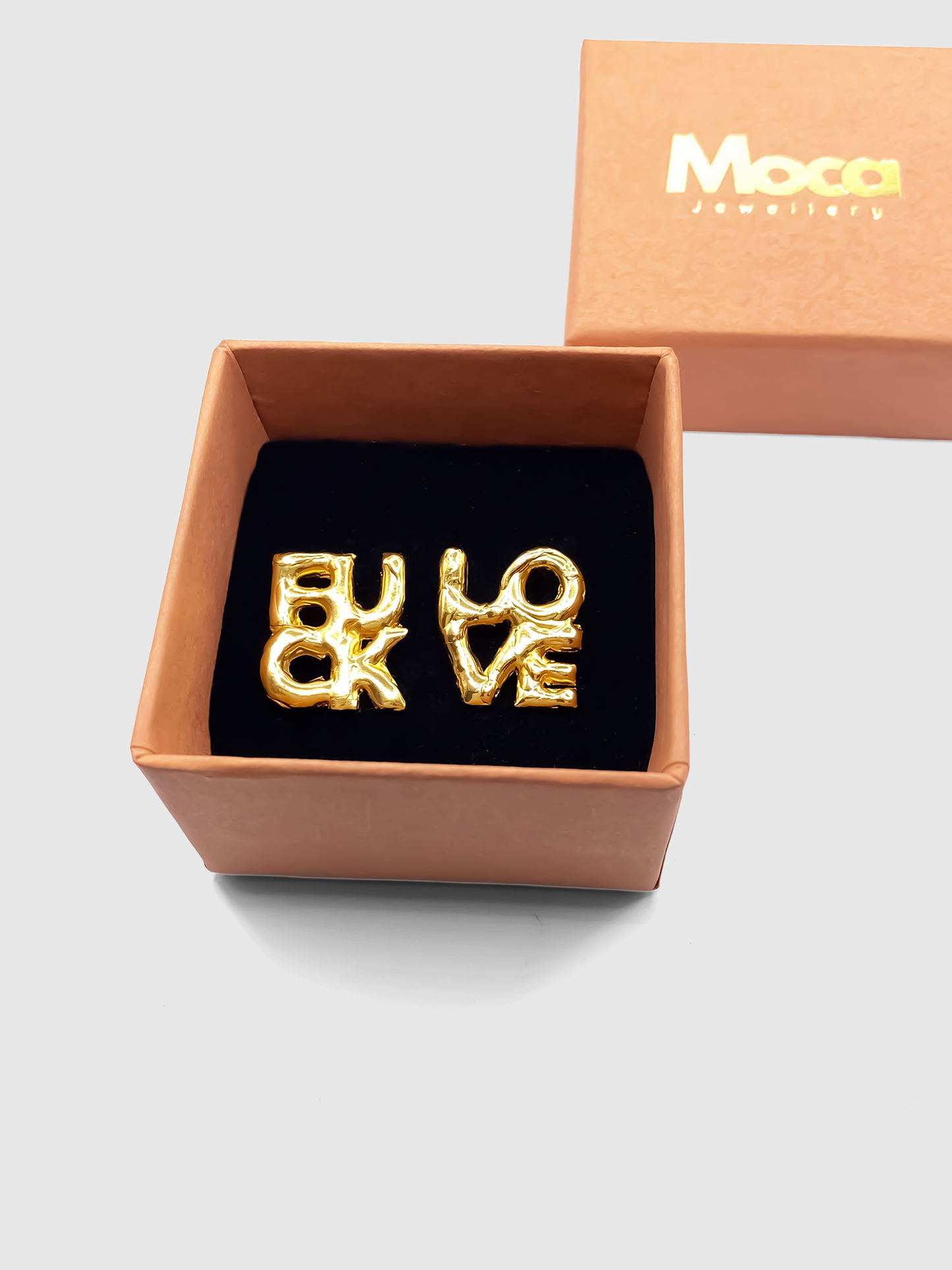FUCK LOVE Earrings in gold presented in MOCA Jewellery packaging – bold cheeky gift-ready studs
