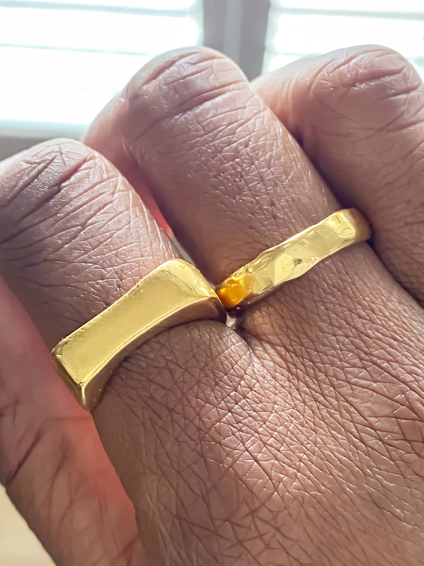 Handcrafted band rings in shiny gold with sculptural textures by MOCA Jewellery.