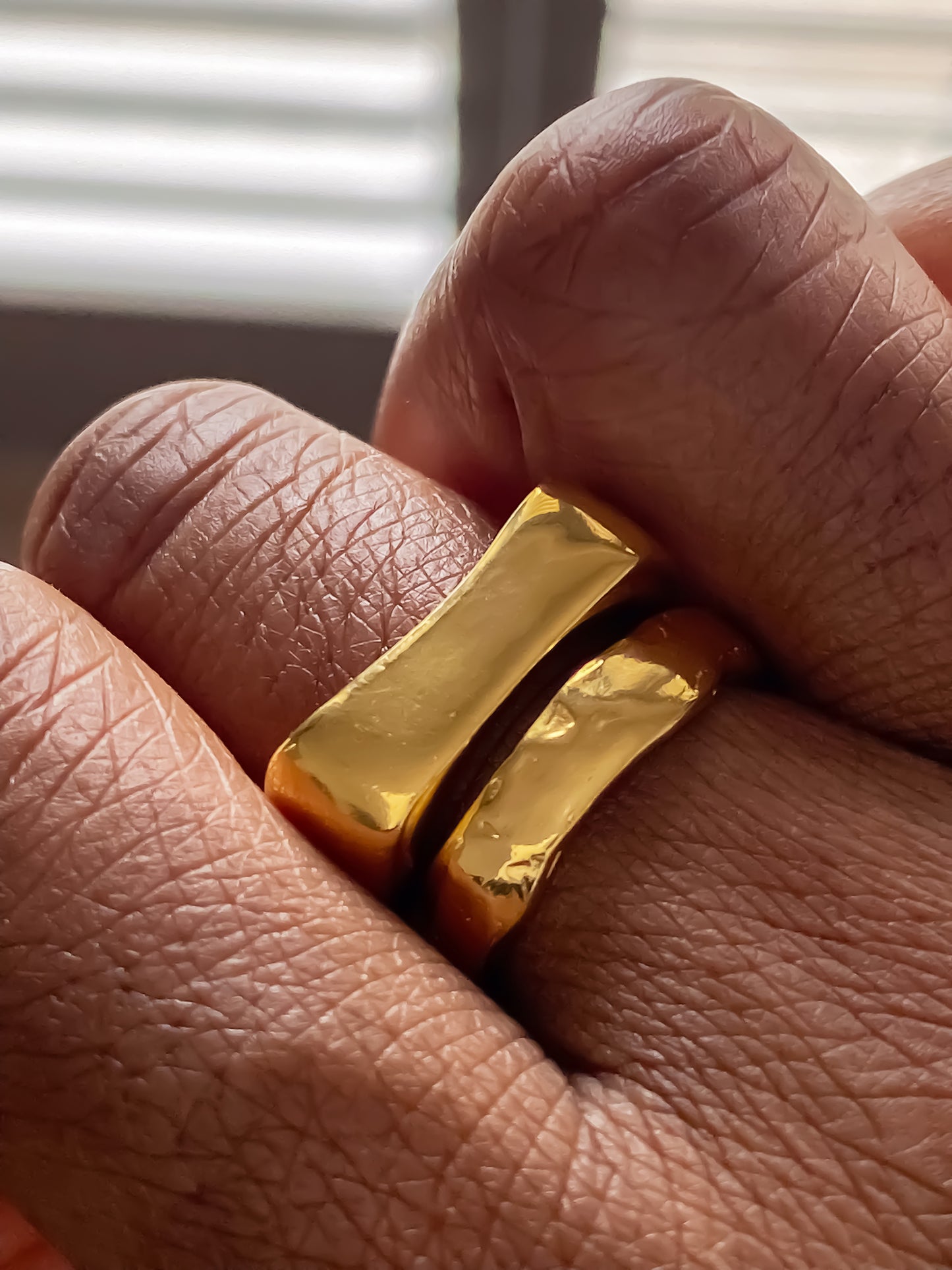Sleek duo of handmade gold rings with clean modern lines from MOCA Jewellery.