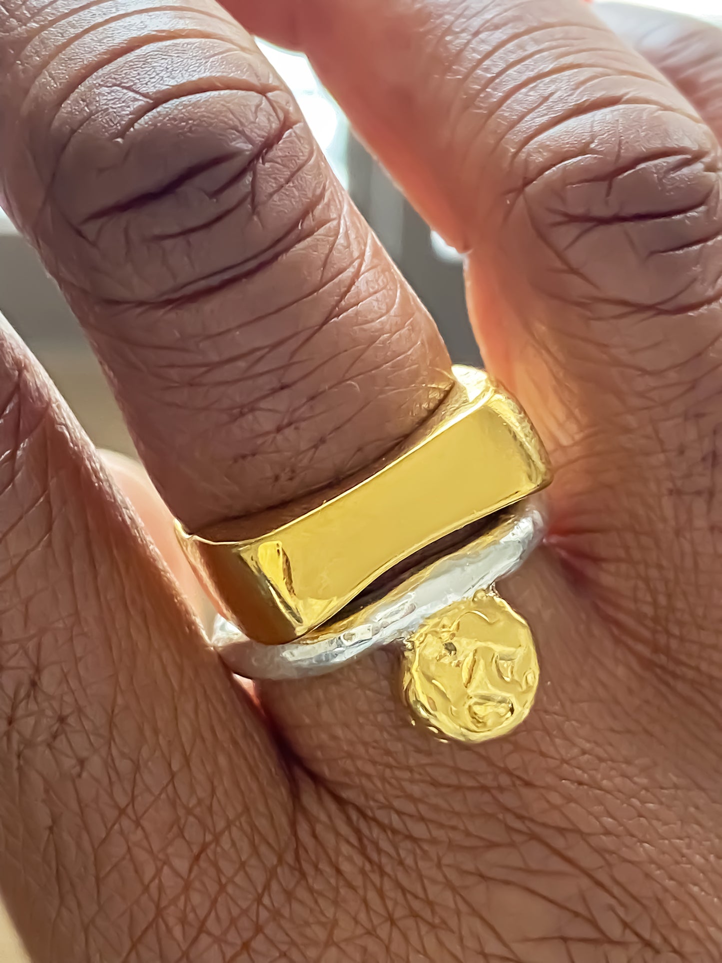 Handmade gold rings featuring sculptural forms and coin charms by MOCA Jewellery.