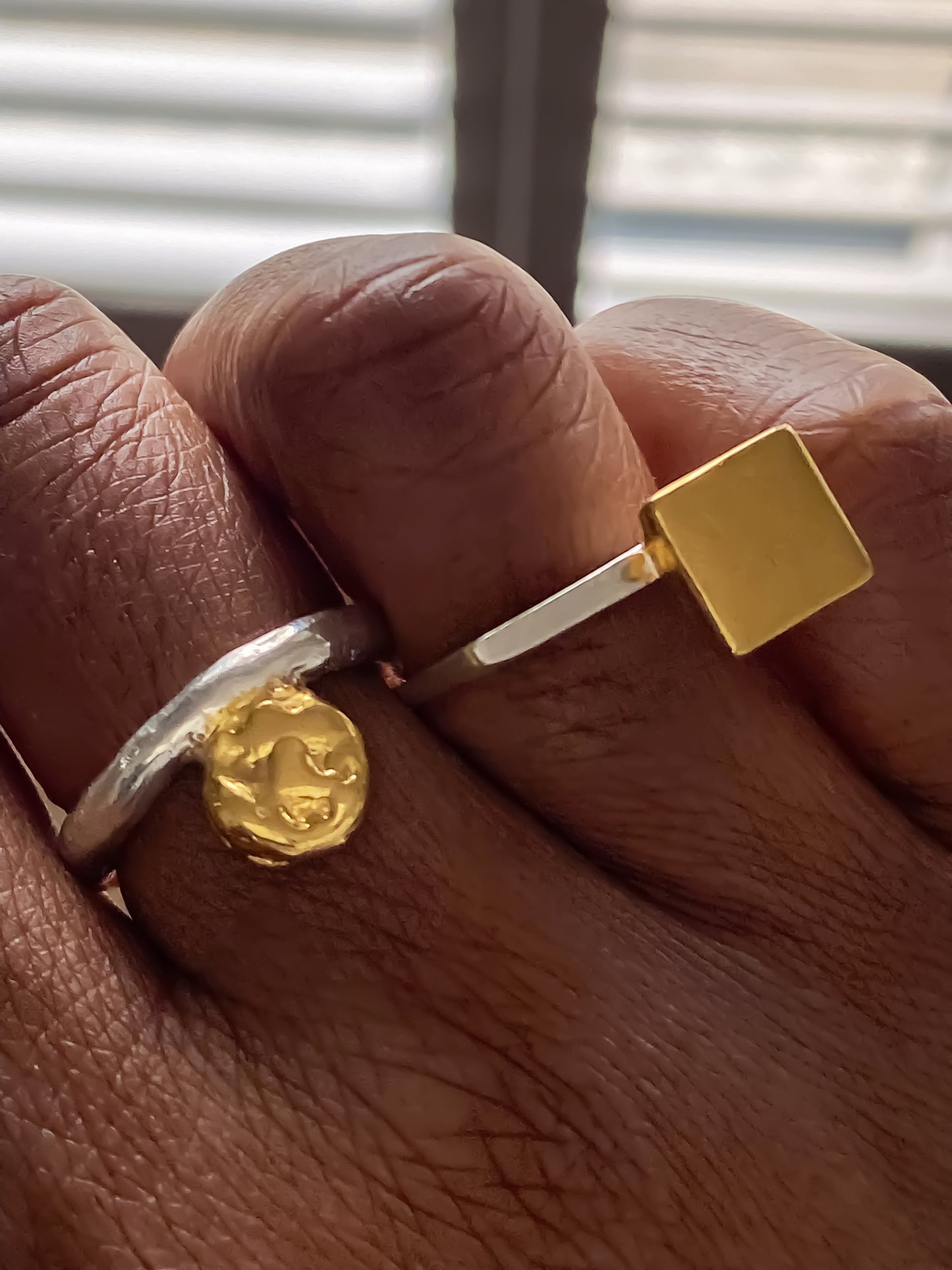 Minimalist square gold ring styled with a textured coin charm ring by MOCA Jewellery.