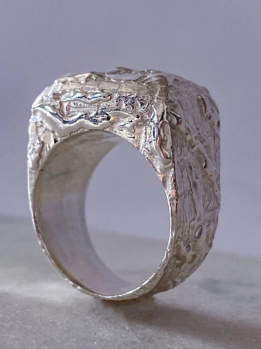 Close-up of the sterling silver Molten Bubble Ring's textured face