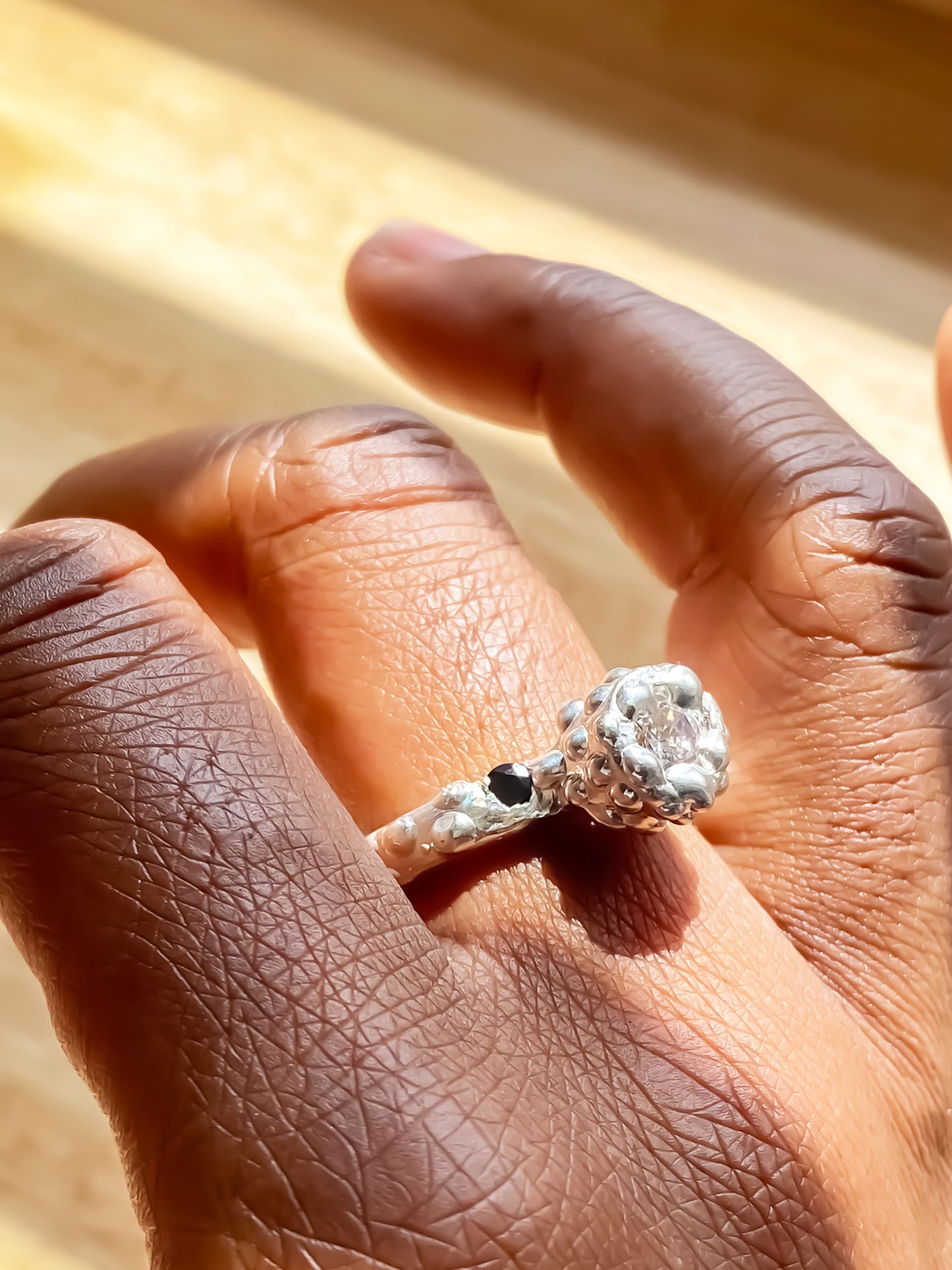 White backdrop Orbit Ring on hand showing full band - abstract, bold white and black gemstones gold or silver free shipping