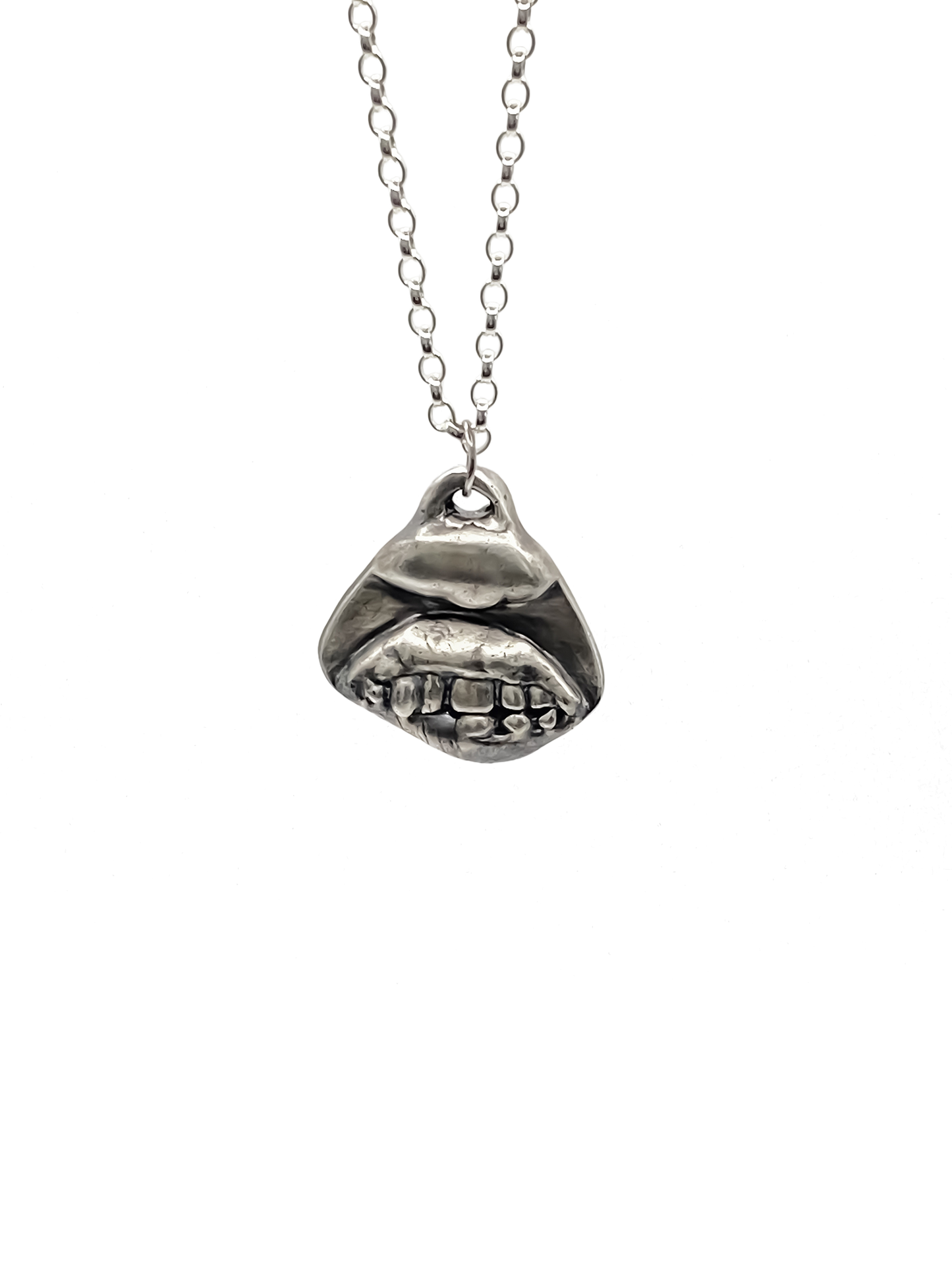 Smiler Pendant shown hanging in frontal view - smile mouth lips teeth charming oxidised organic texture gold or silver free shipping