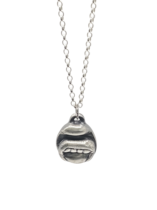 Tongue & Teeth Pendant shown hanging front-facing - tongue smile mouth lips charming oxidised organic texture gold or silver free shipping
