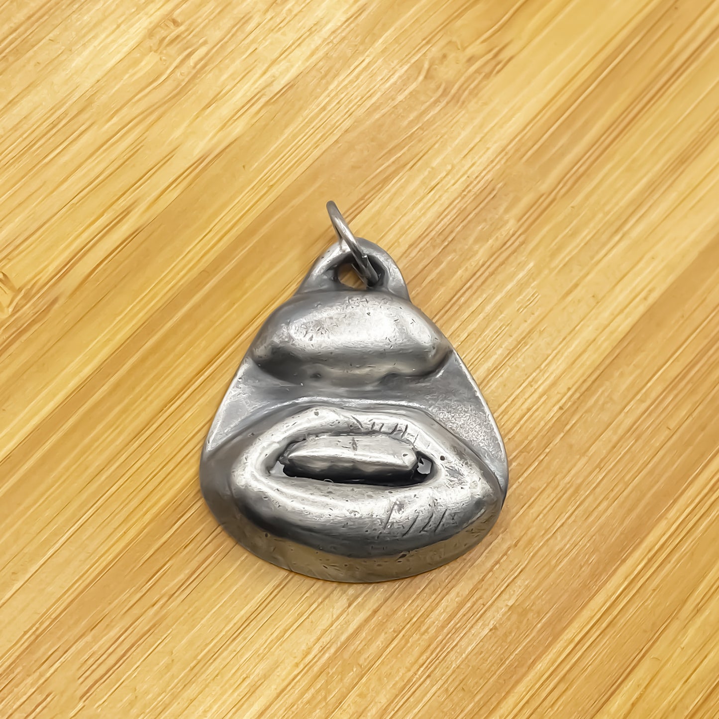 Two Teeth Pendant placed on wood background - smile mouth lips charming oxidised organic texture gold or silver free shipping