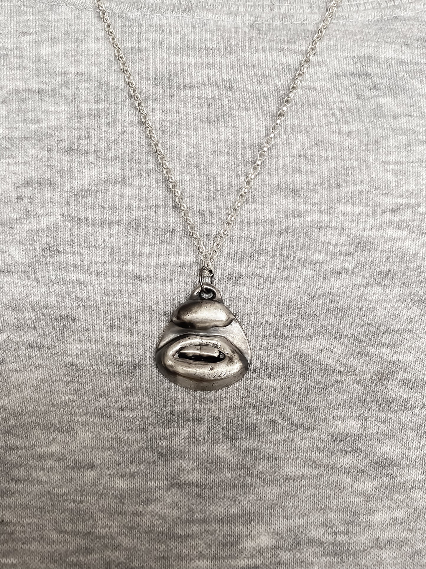 Two Teeth Pendant worn with grey top for contrast - smile mouth lips charming oxidised organic texture gold or silver free shipping