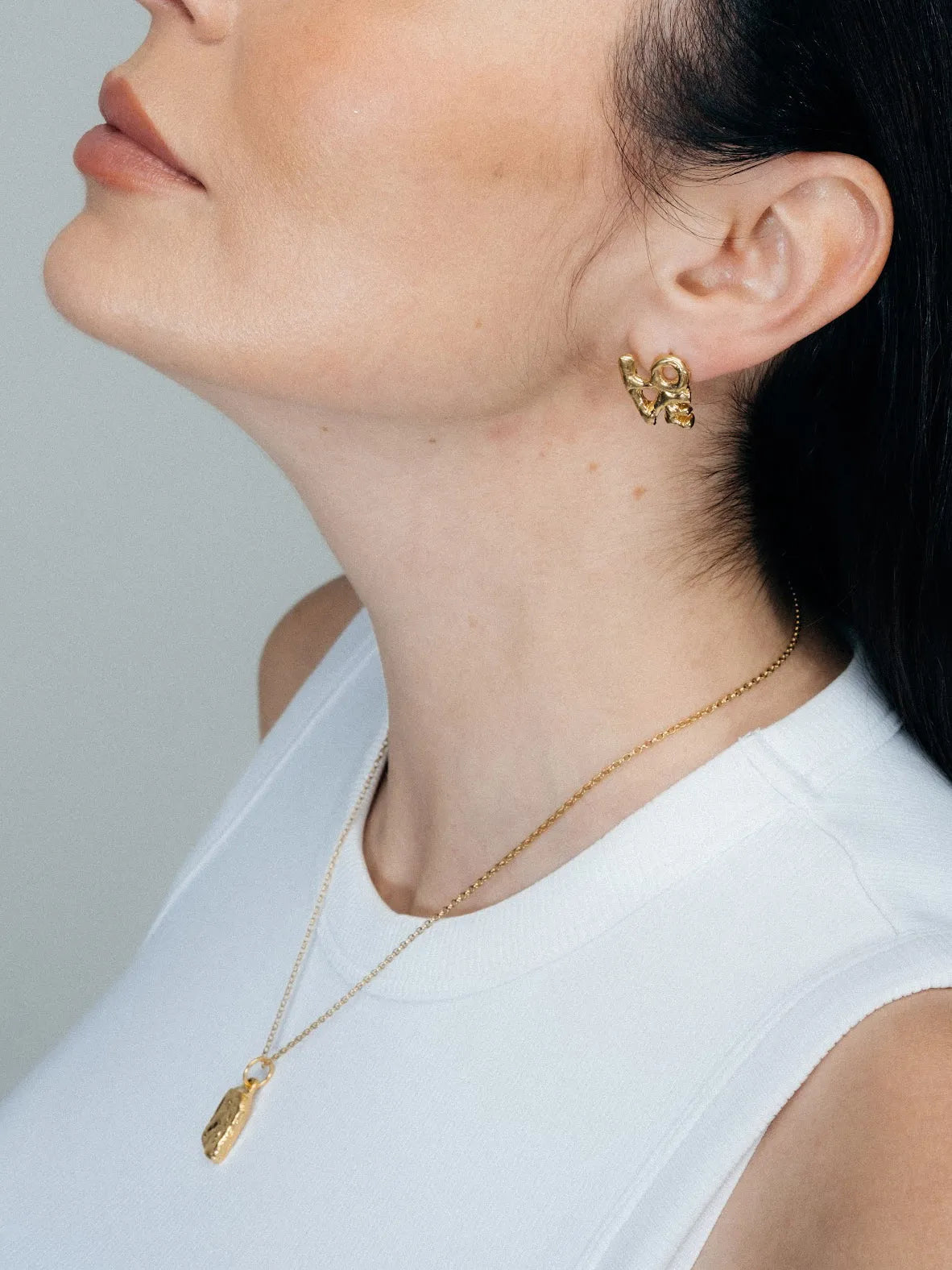 Artisan Fuck/Love Earrings in premium premium metal, refined finish, angle view