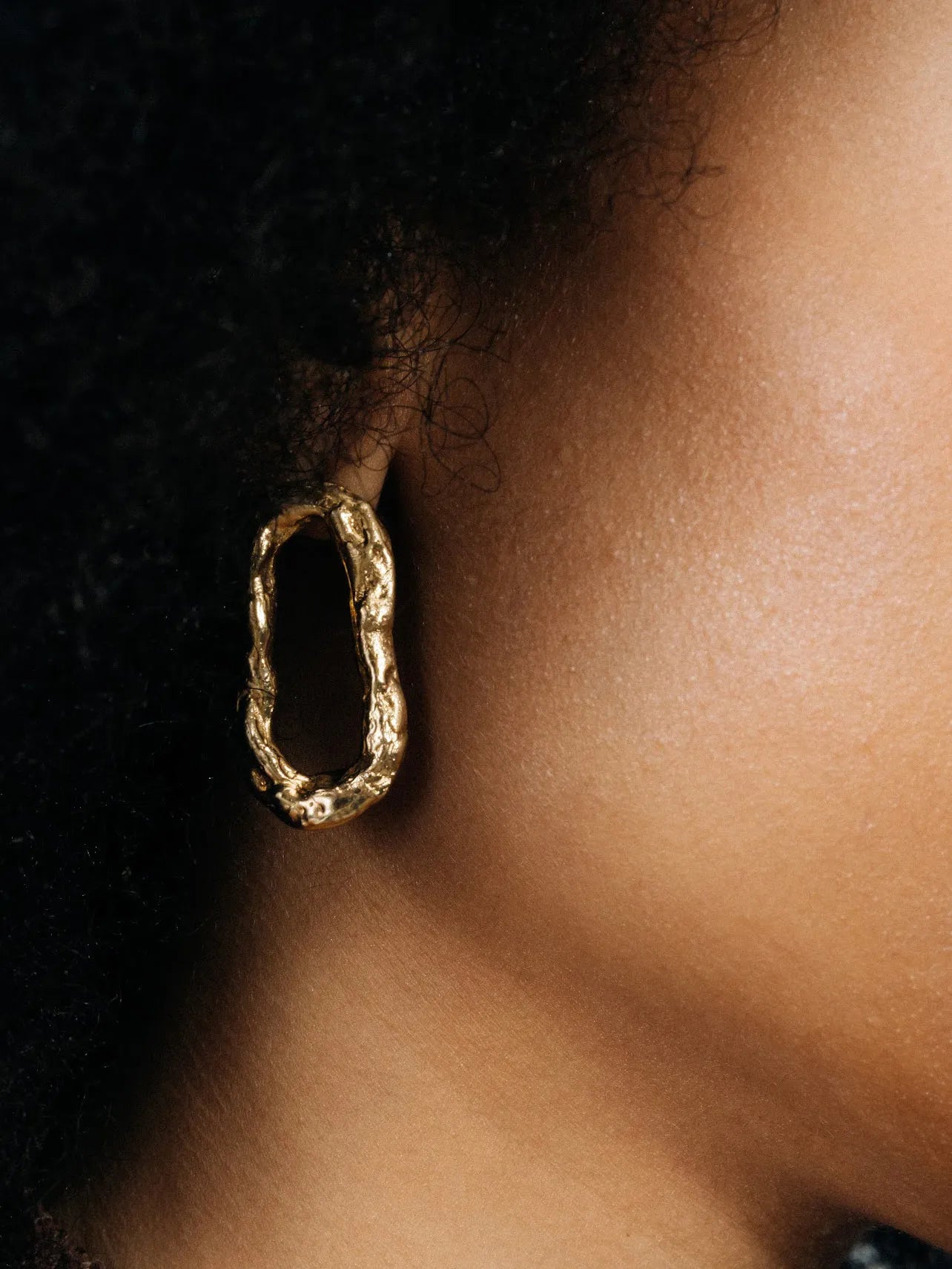 Artisan Flow Loop Earrings in premium premium metal, refined finish, angle view