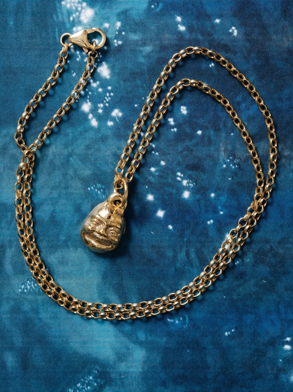 Small Buddha Face Necklace luxury artisan necklace in Sterling silver, meditative piece, styled view