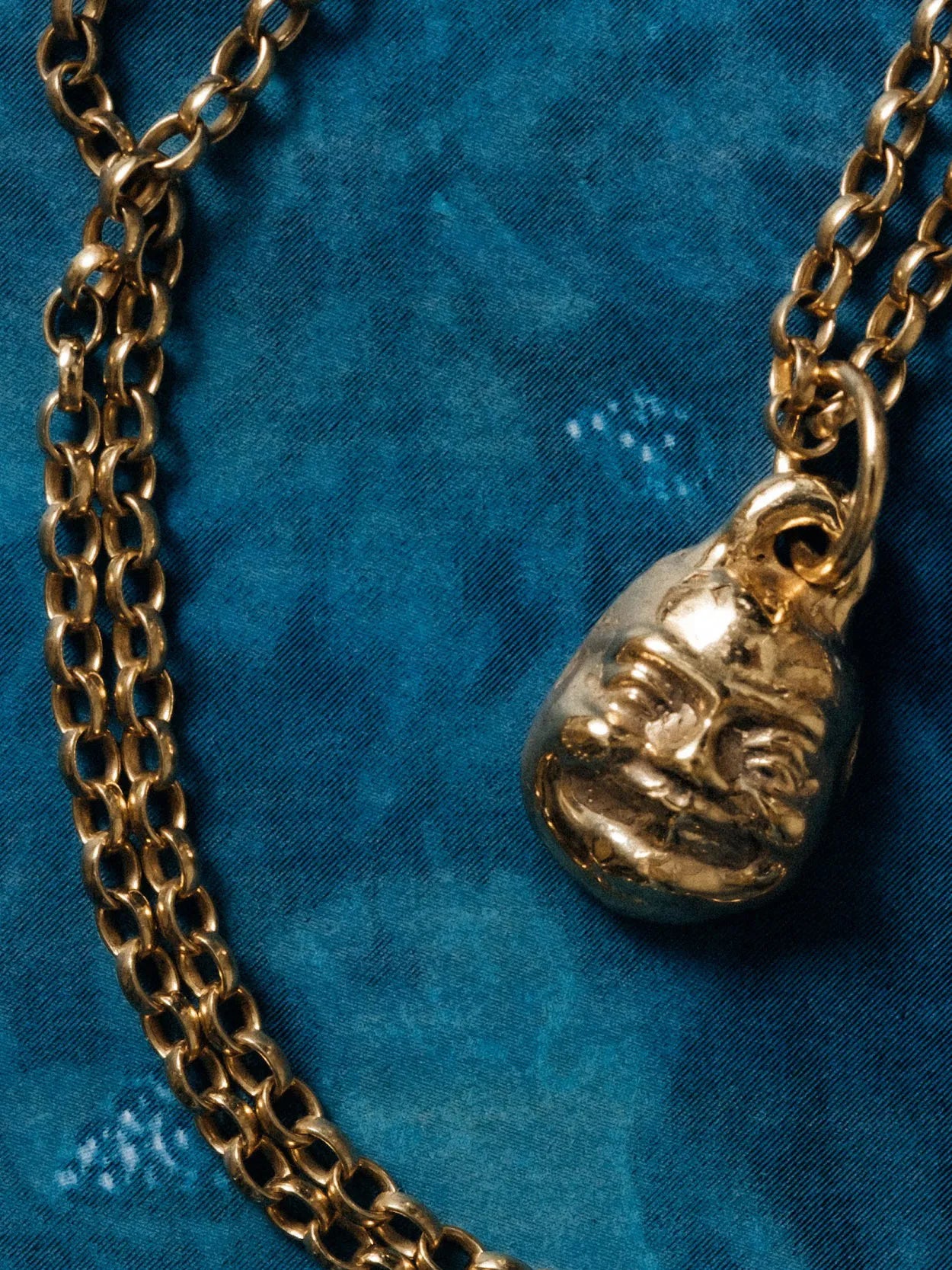 Small Buddha Face Necklace designer necklace in Sterling silver, serene face, side view