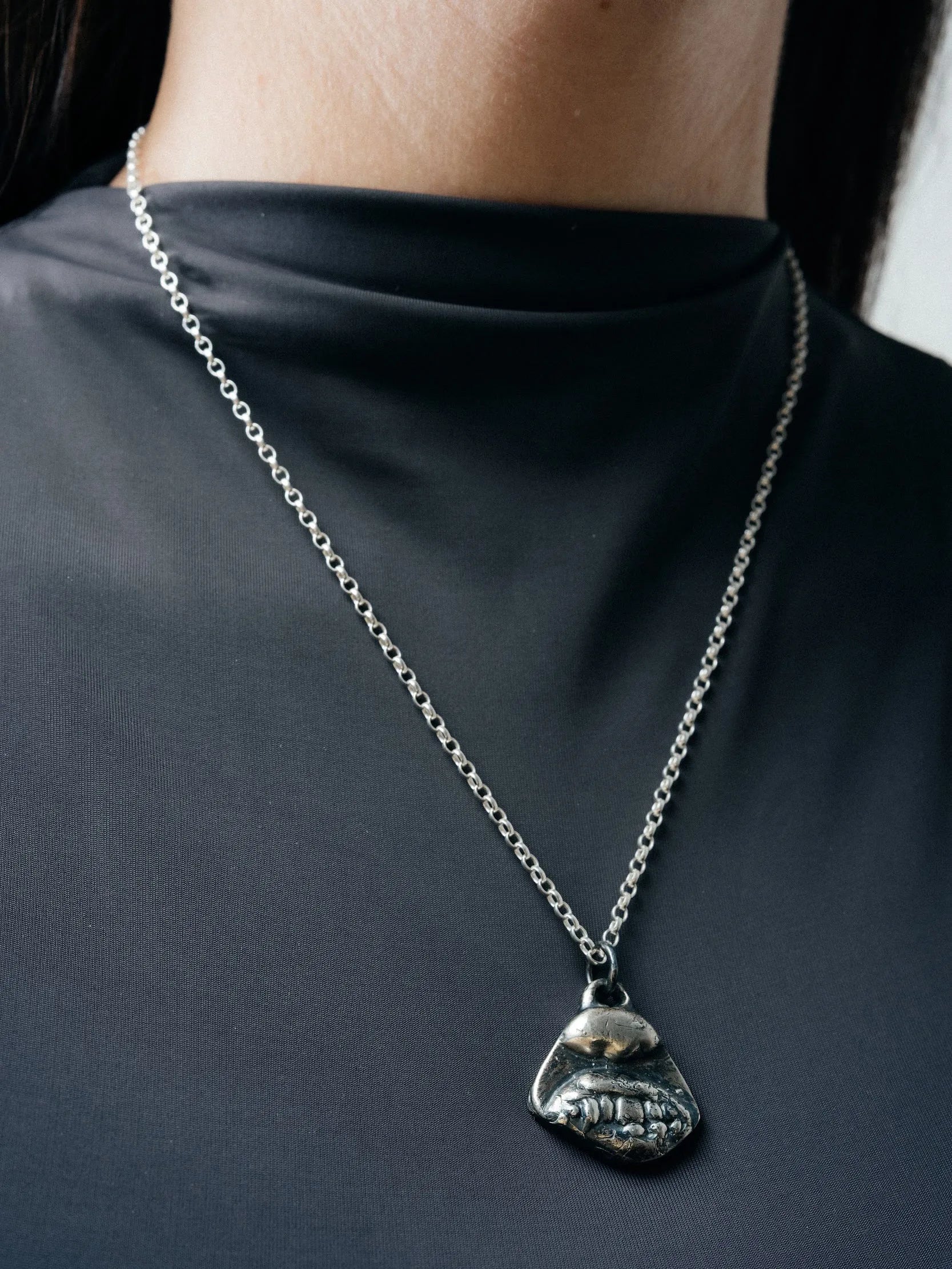 Artisan Smiler Necklace in premium Patina, cheerful jewelry, angle view