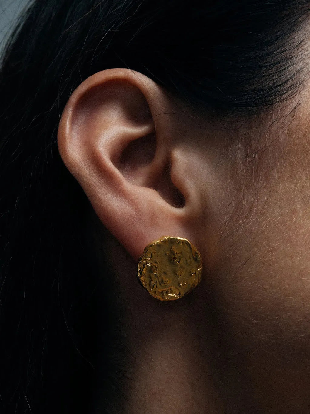 Artisan Grain Circle Stud Earrings in premium premium metal, refined finish, angle view