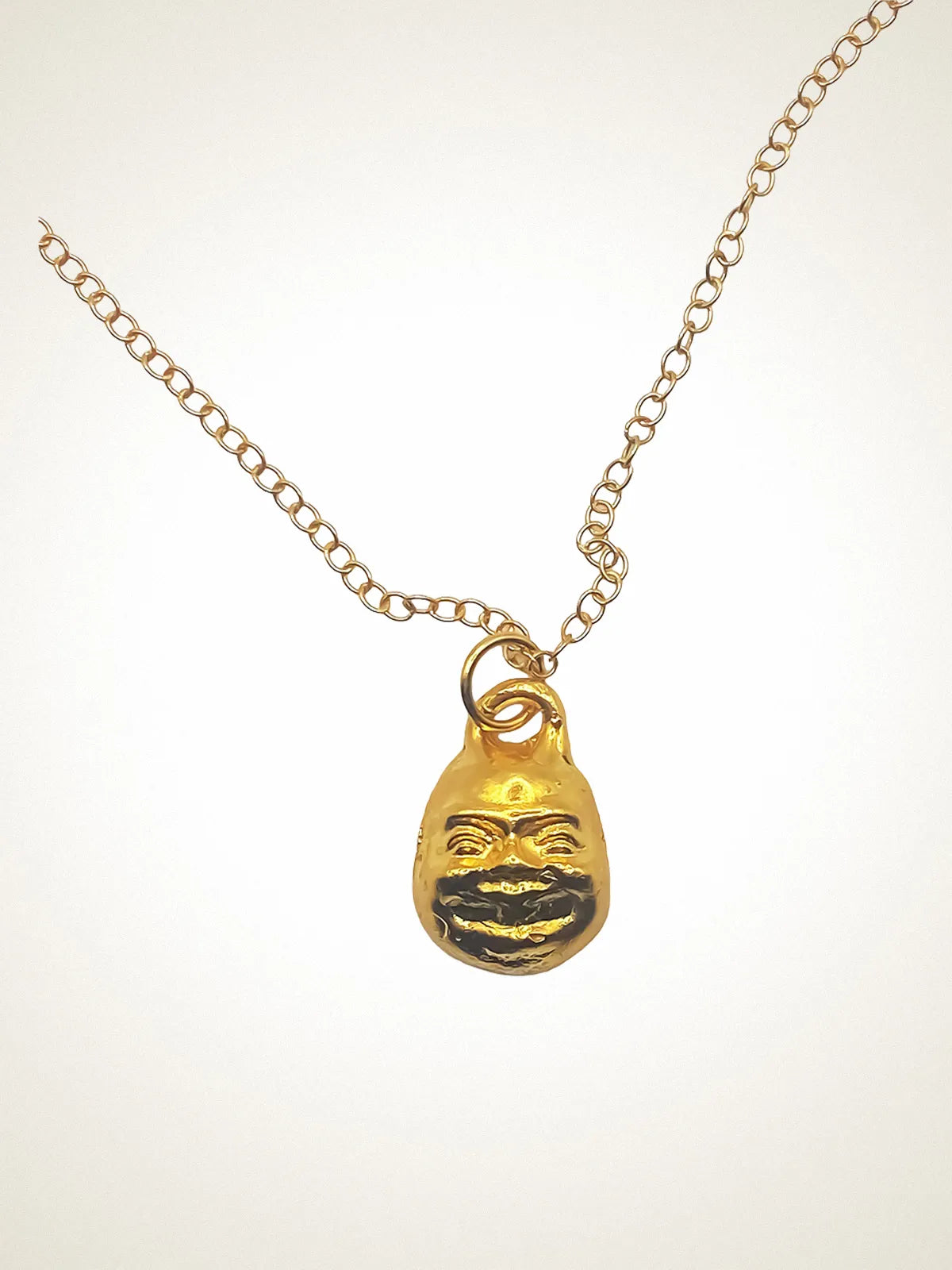 Small Buddha Face Necklace artisan crafted necklace in 18ct Gold Vermeil, zen design, lifestyle shot