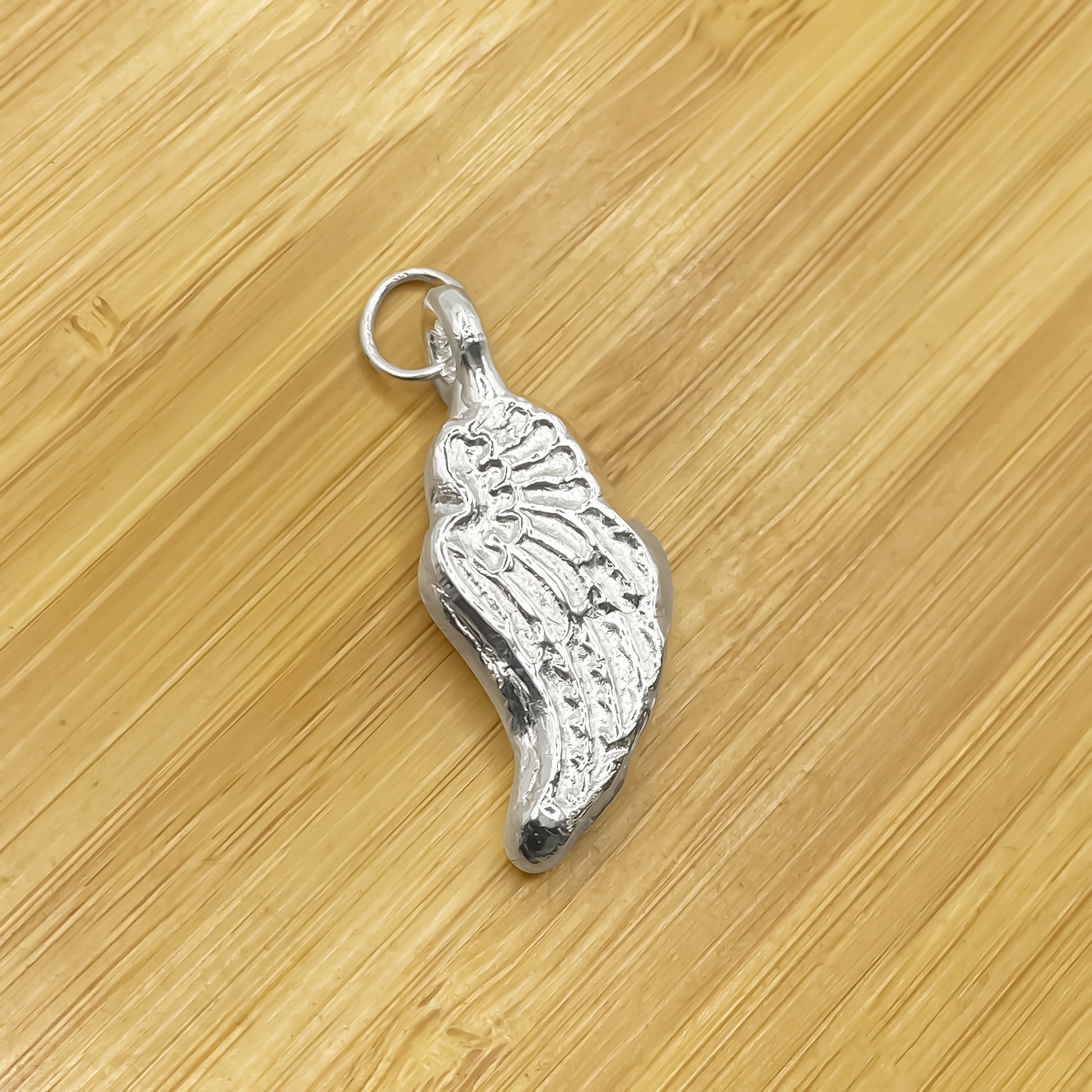 Close-up of Angel Wing Pendant with detailed feather texture, guardian 11:11 gold or silver free shipping
