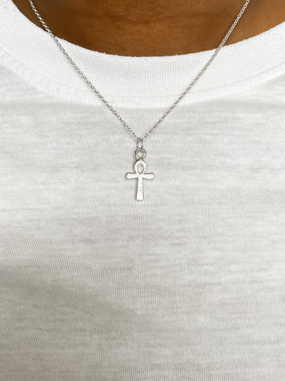 Ankh Pendant on white cloth background in silver or gold. Egyptian African