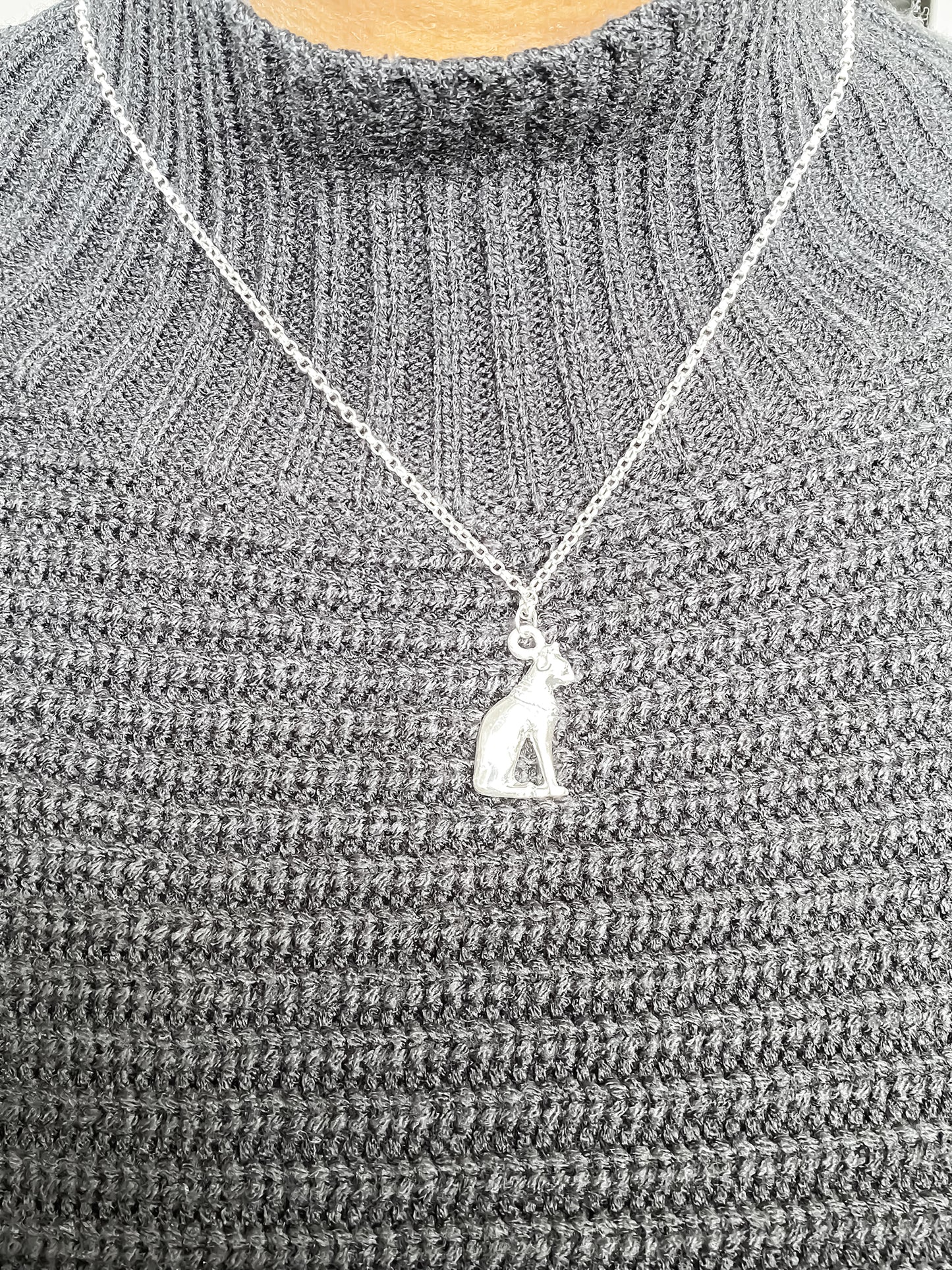 Bast Cat Pendant worn on chain, showing oxidised Egyptian detailing. Silver or Gold. 