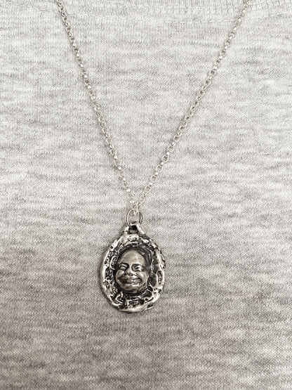 Happy Buddha Face Pendant styled with grey knit backdrop - happy buddha, spiritual, oxidised organic texture gold or silver free shipping