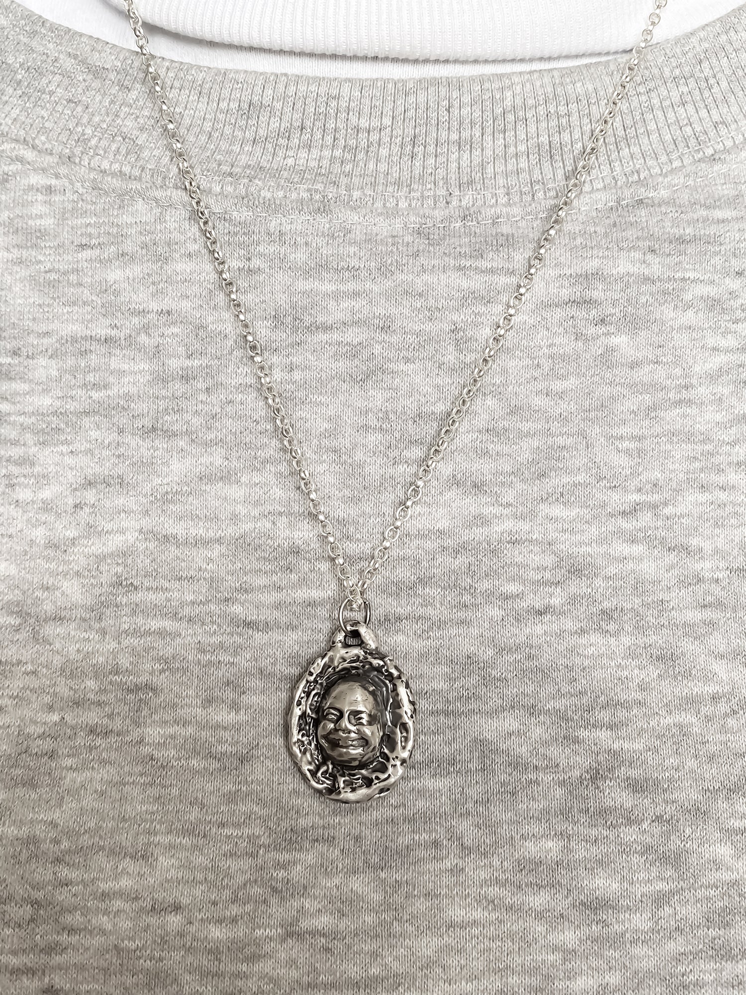 Worn Buddha Face Pendant photographed with soft grey - happy buddha, spiritual, oxidised organic texture gold or silver free shipping