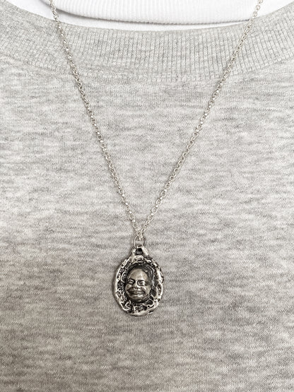Worn Buddha Face Pendant photographed with soft grey - happy buddha, spiritual, oxidised organic texture gold or silver free shipping