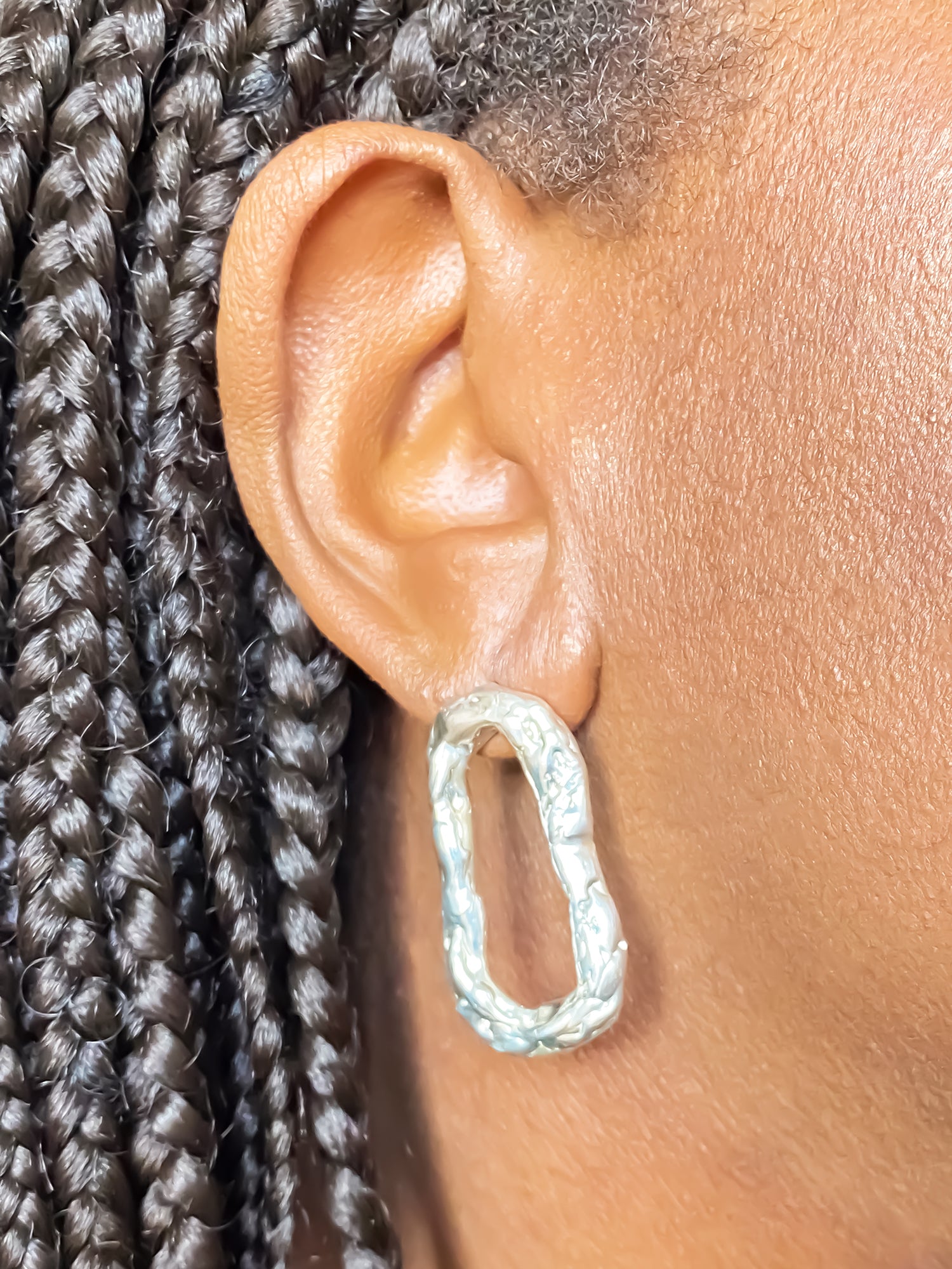 Close-up of Flow Loop Earrings worn, sleek and sculptural, gold or silver, free shipping