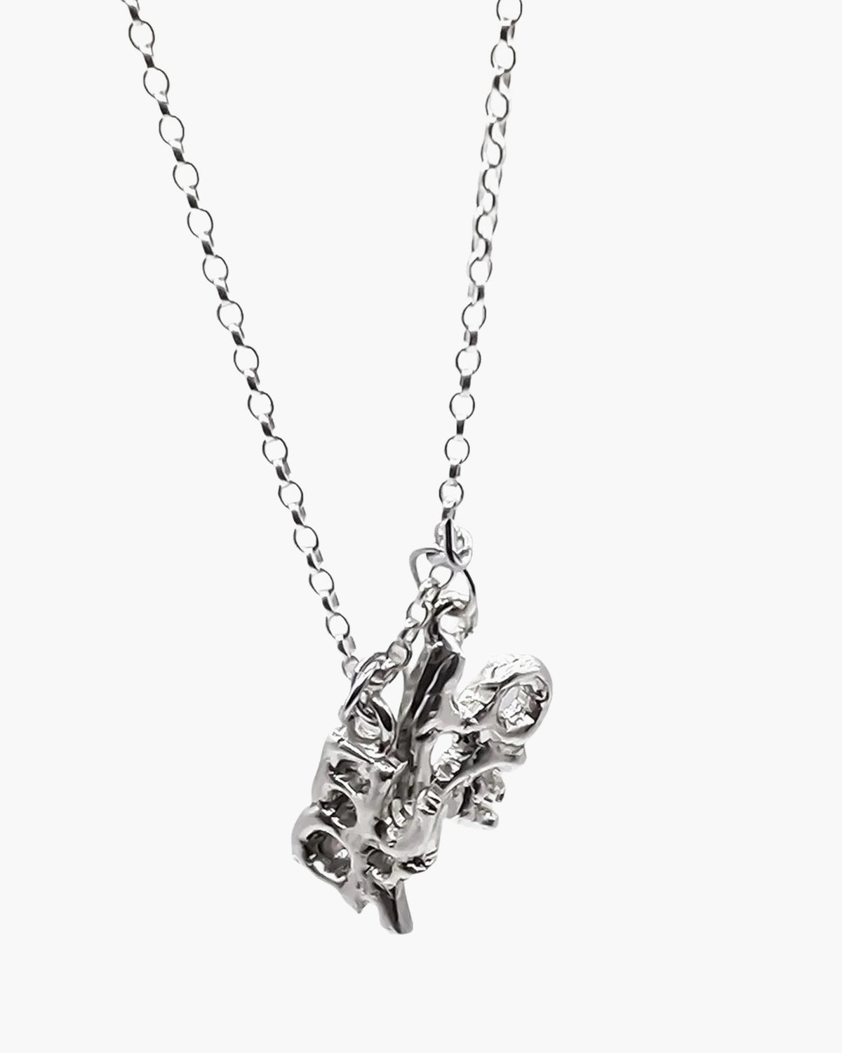 Sterling silver Fuck + Love pendant at an angle