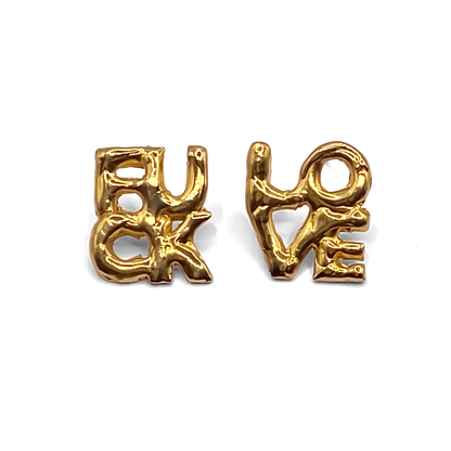Flatlay of gold FUCK LOVE Earrings – minimal and bold cheeky studs by MOCA Jewellery