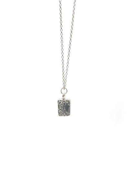 Minimal rectangular sculpted pendant hanging from chain, sleek textured silver or gold with delicate details and free shipping