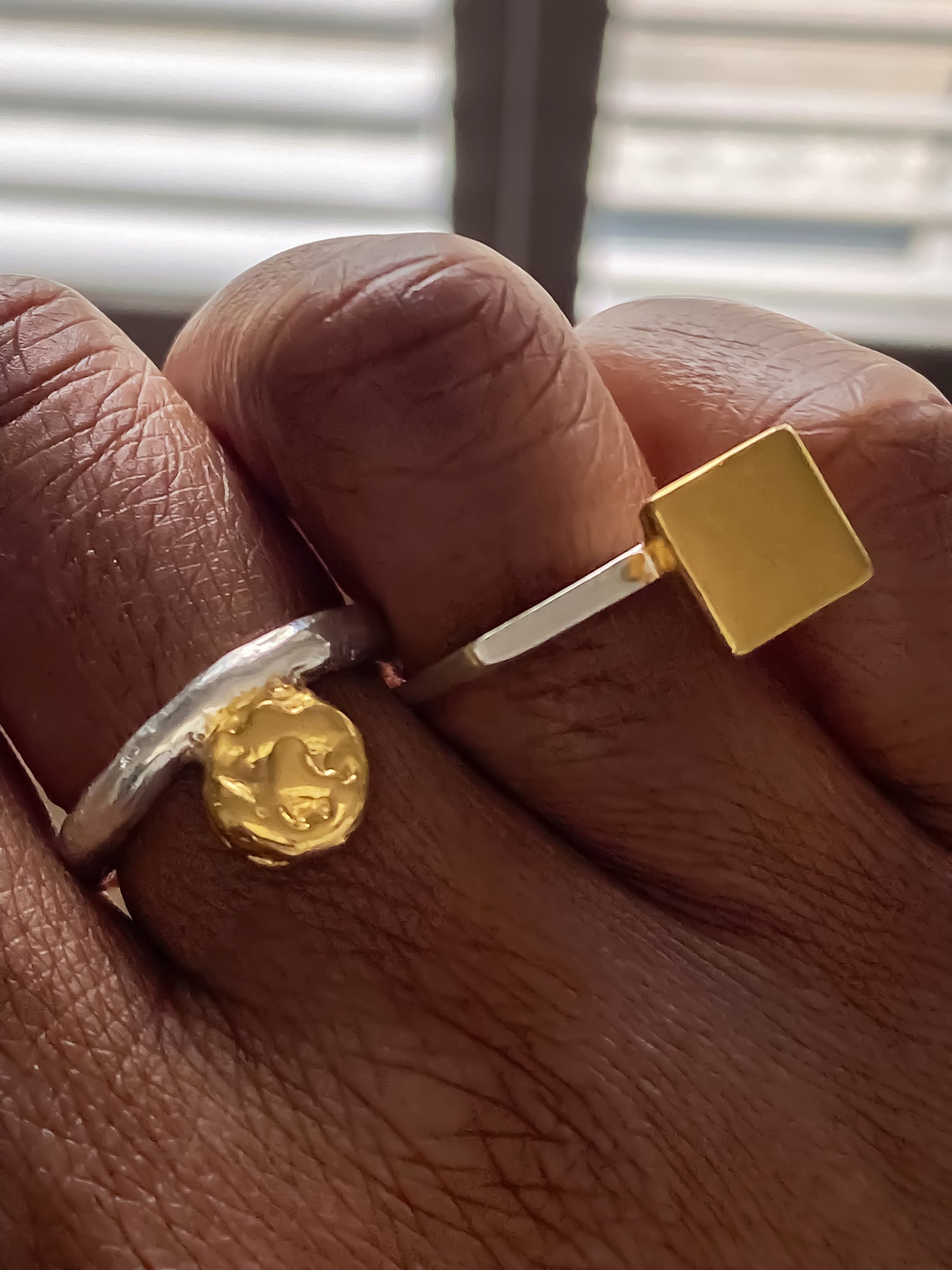 Minimalist square gold ring styled with a textured coin charm ring by MOCA Jewellery.