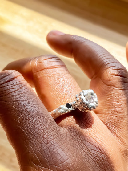 White backdrop Orbit Ring on hand showing full band - abstract, bold white and black gemstones gold or silver free shipping