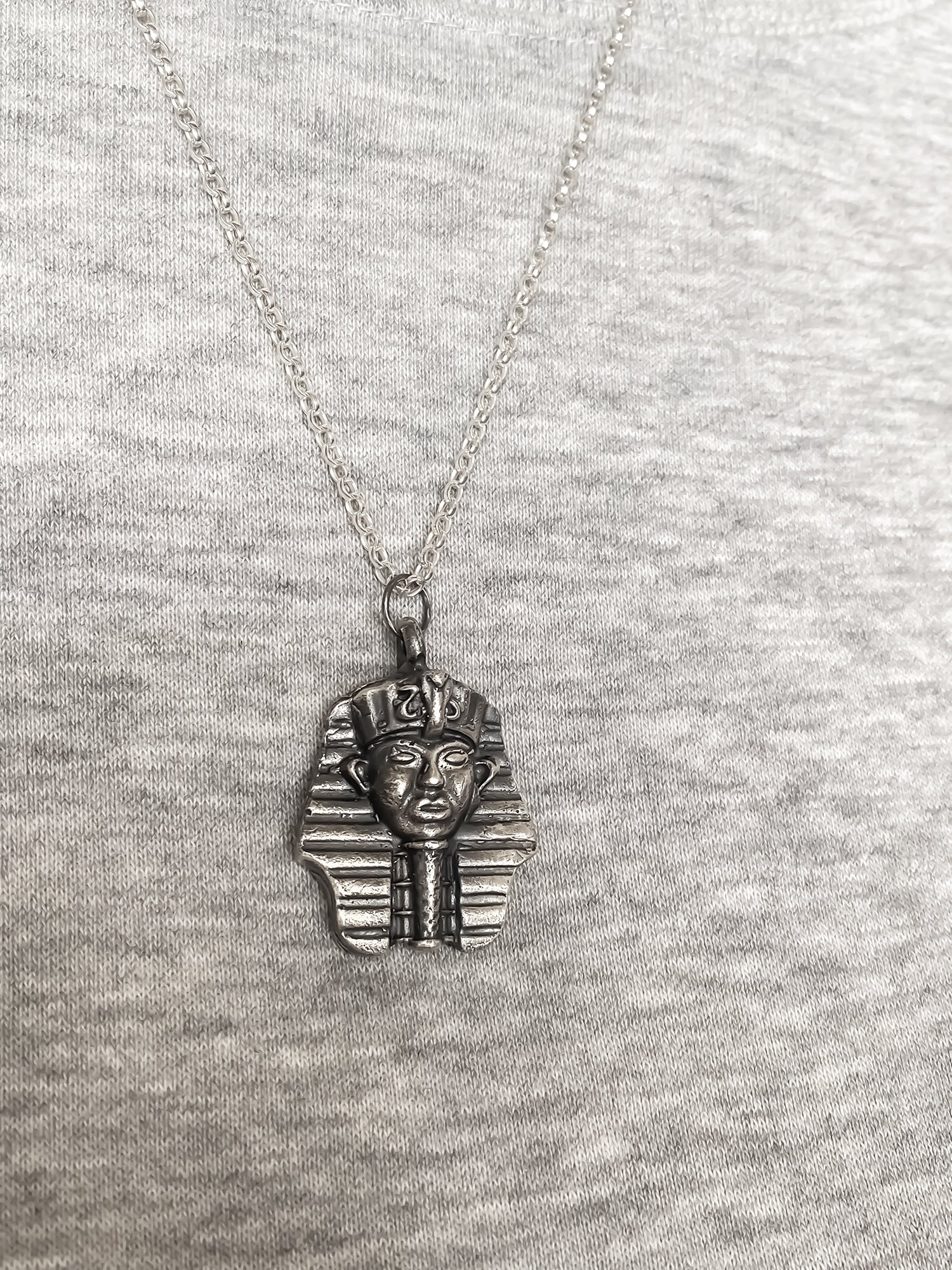 Pharaoh Pendant styled on grey background - oxidised Egyptian African gold or silver free shipping