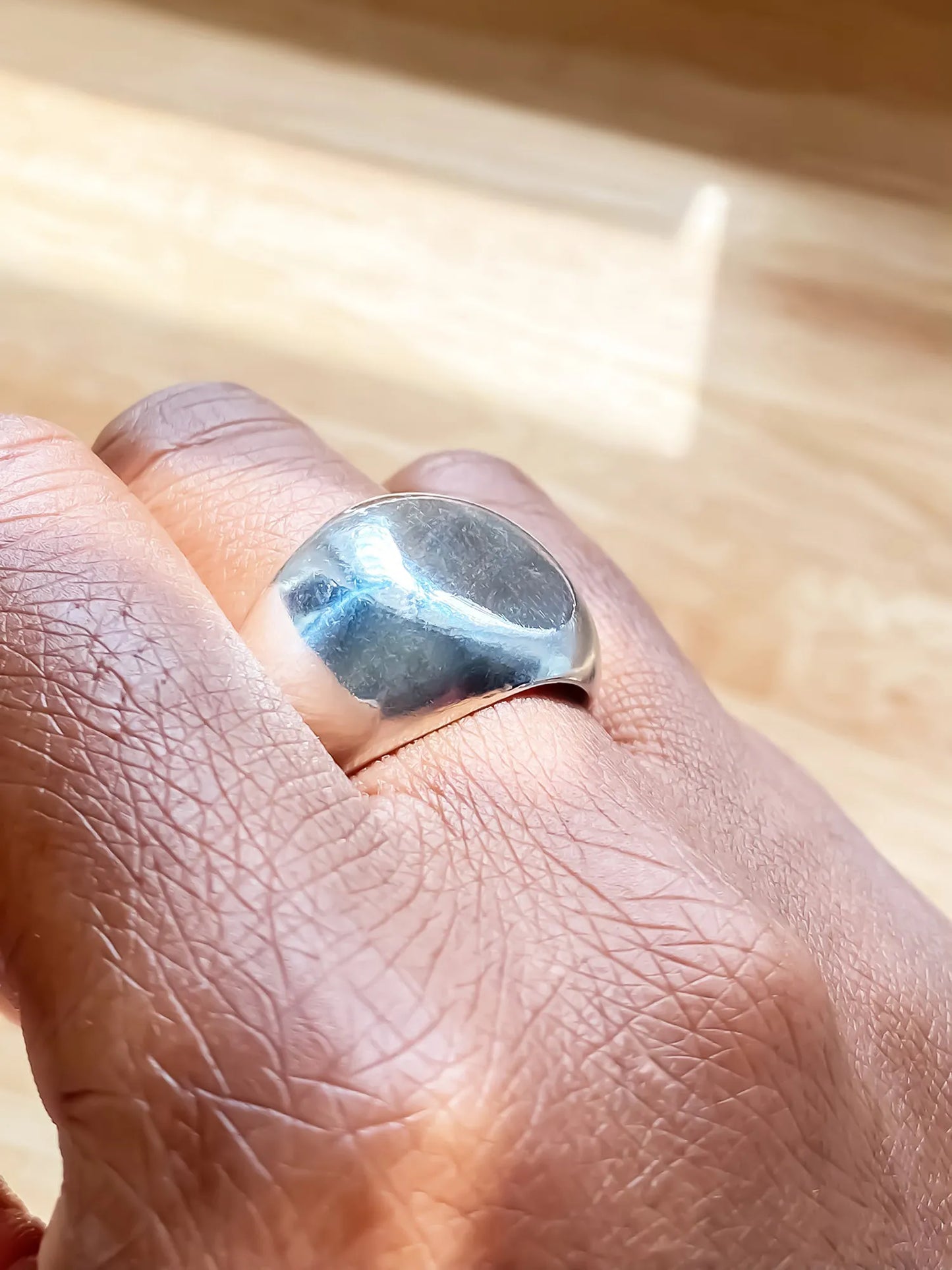 Artisan Round Signet Ring in premium premium metal, minimal design, angle view