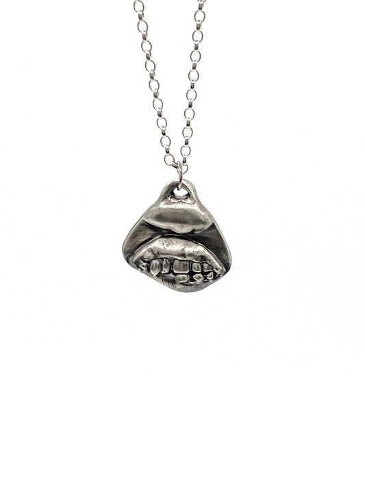 Smiler Pendant shown hanging in frontal view - smile mouth lips teeth charming oxidised organic texture gold or silver free shipping