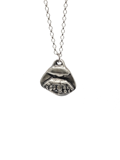 Smiler Pendant shown hanging in frontal view - smile mouth lips teeth charming oxidised organic texture gold or silver free shipping