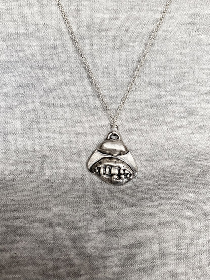 Smiler Pendant worn over grey knit for everyday styling - smile mouth lips teeth charming oxidised organic texture gold or silver free shipping