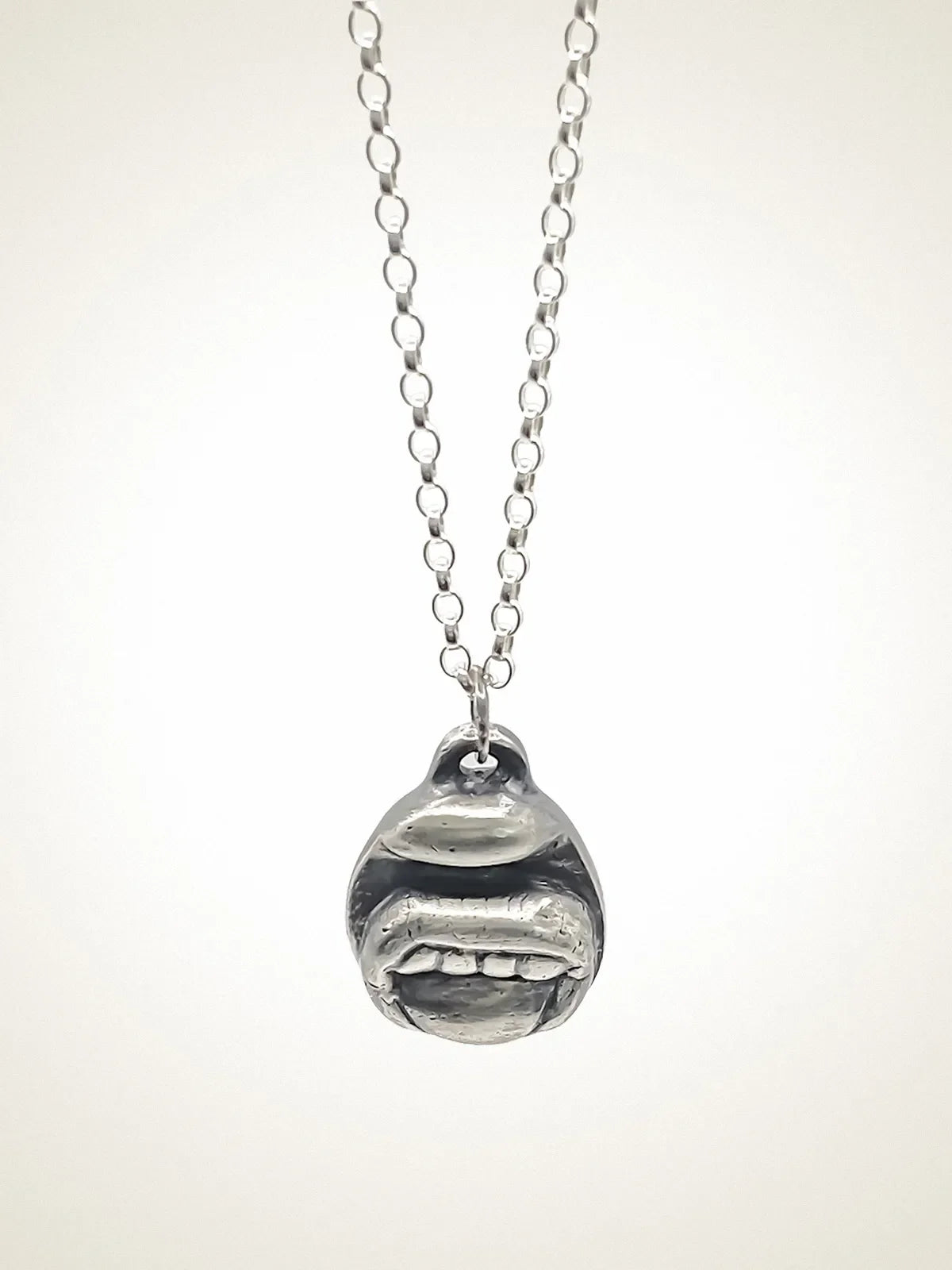 Tongue & Teeth Necklace artisan crafted necklace in premium metal, timeless style, lifestyle shot