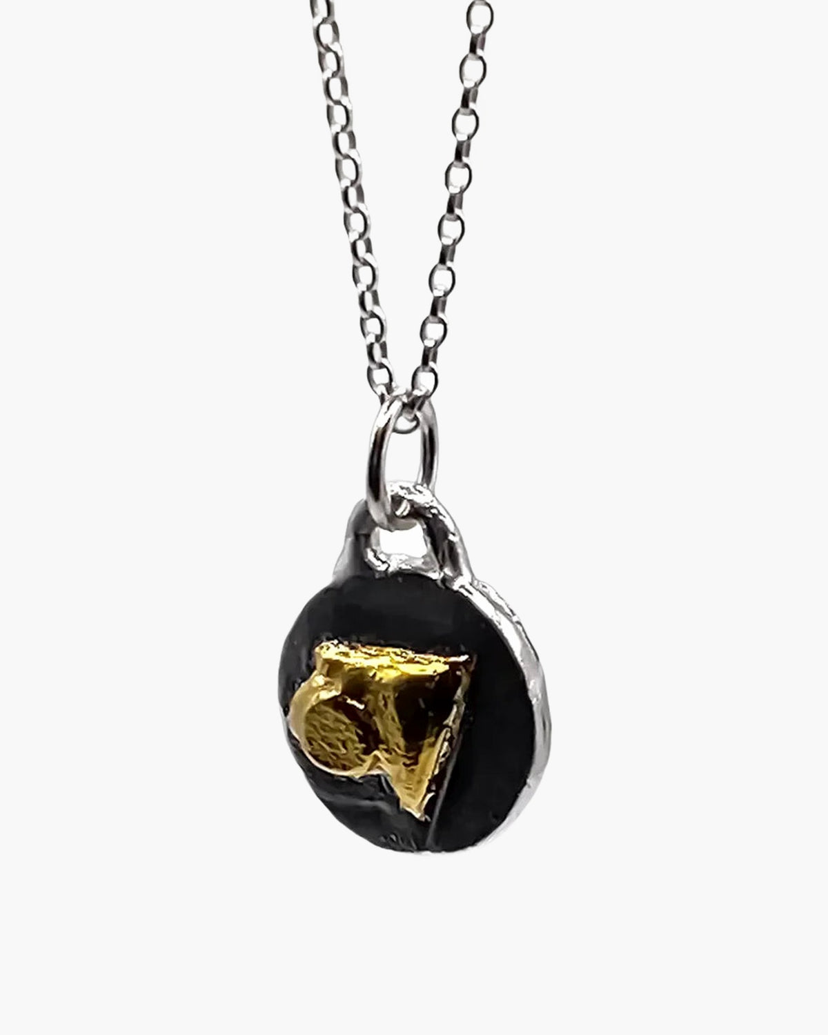 Oxidised disc pendant with gold triangle, front view