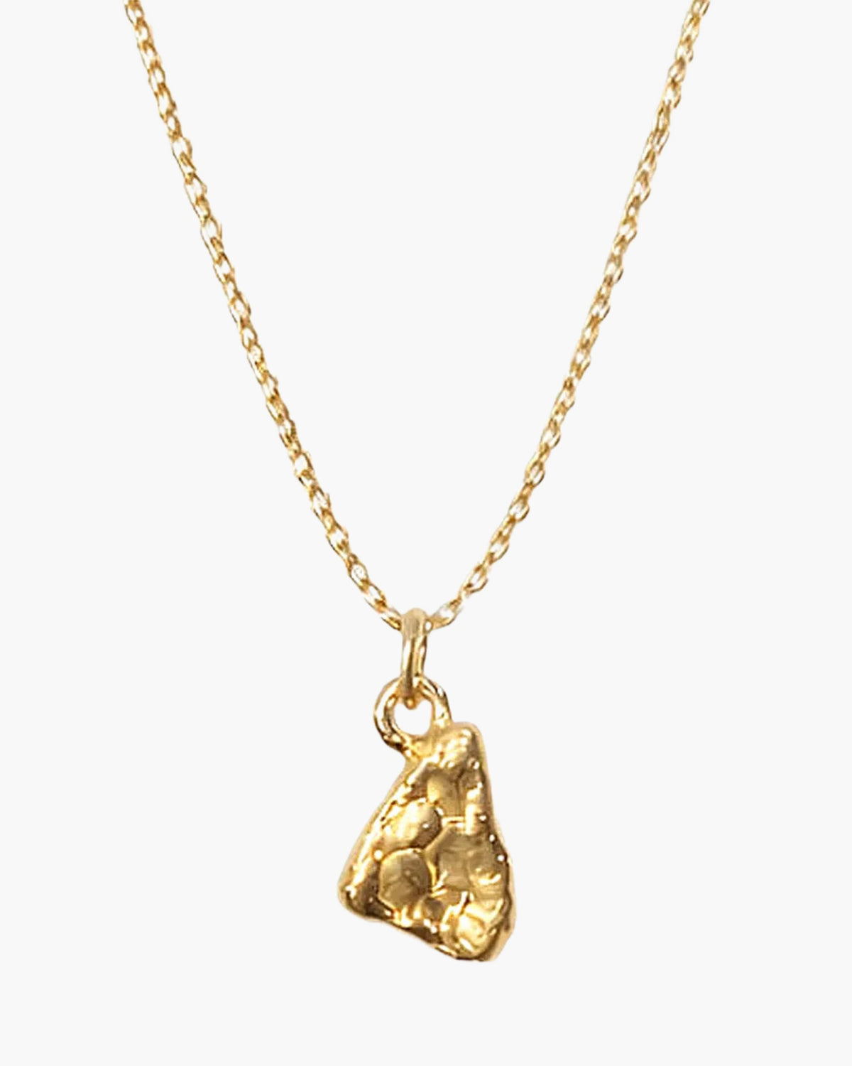 Close-up of the gold vermeil Triad Spark pendant