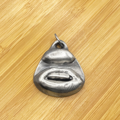 Two Teeth Pendant placed on wood background - smile mouth lips charming oxidised organic texture gold or silver free shipping