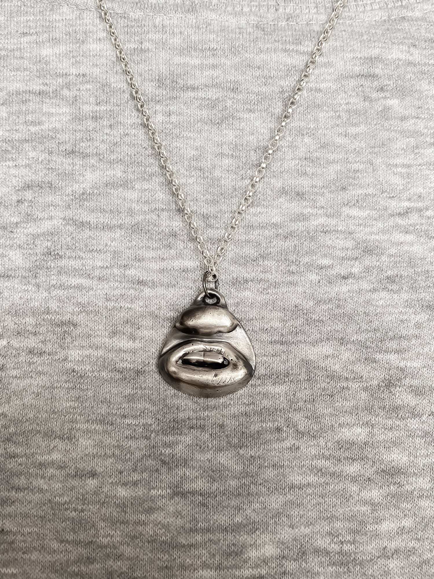 Two Teeth Pendant worn with grey top for contrast - smile mouth lips charming oxidised organic texture gold or silver free shipping